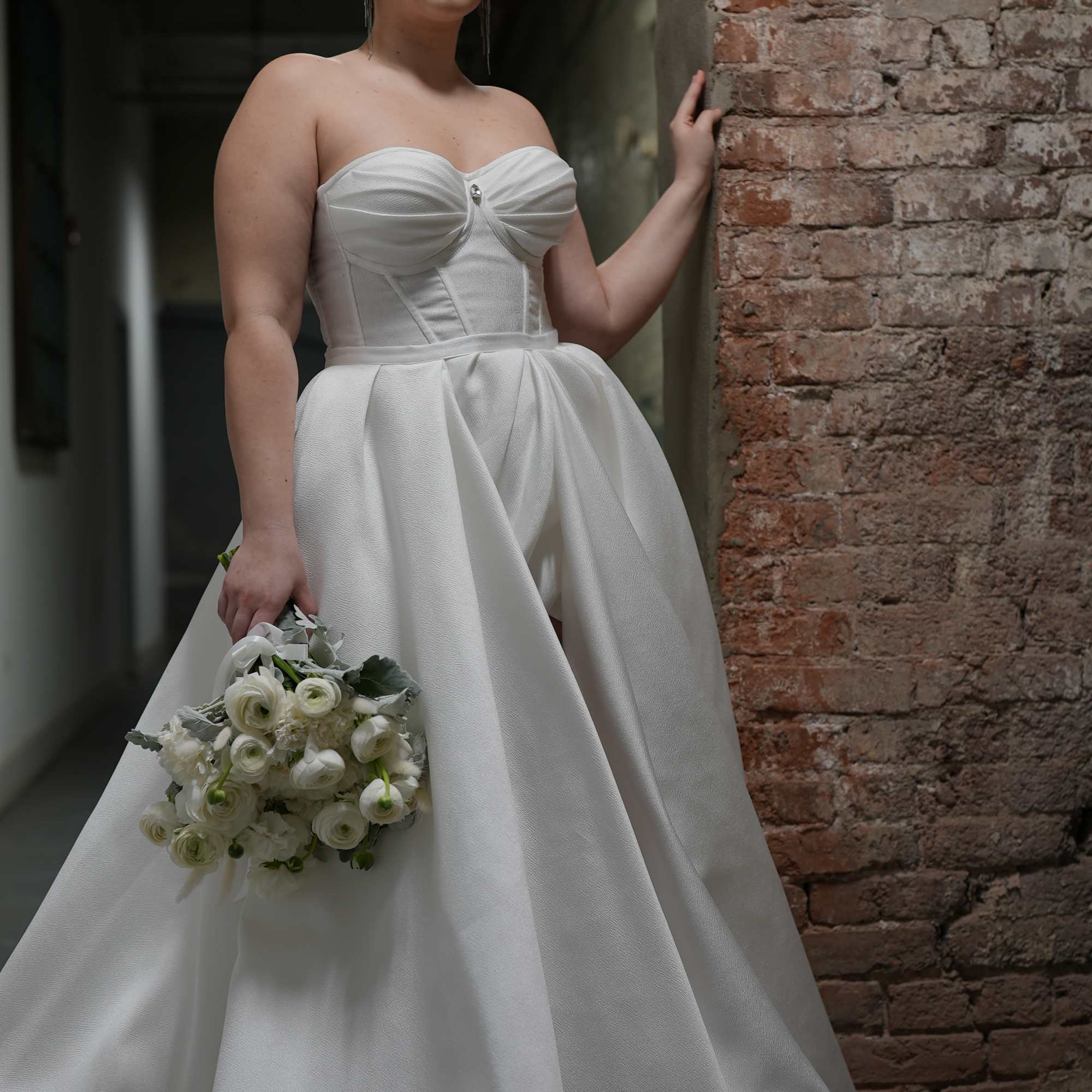 Bride in a white gown holding a white bouquet