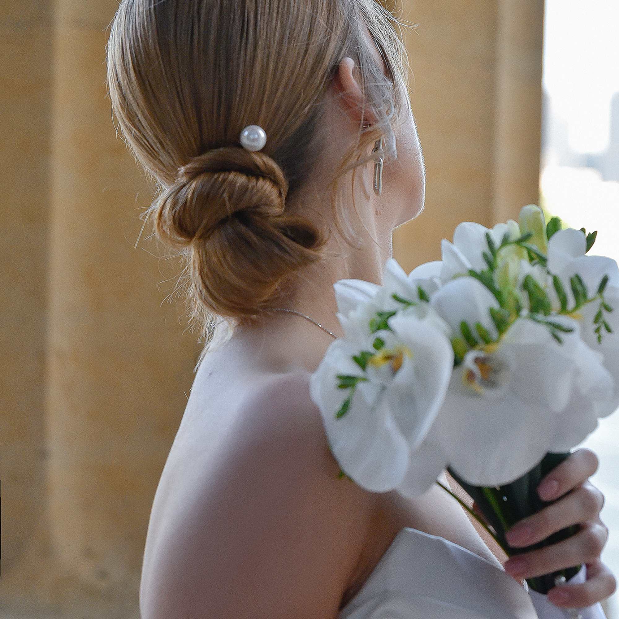 Bride holding a bouquet of white orchids