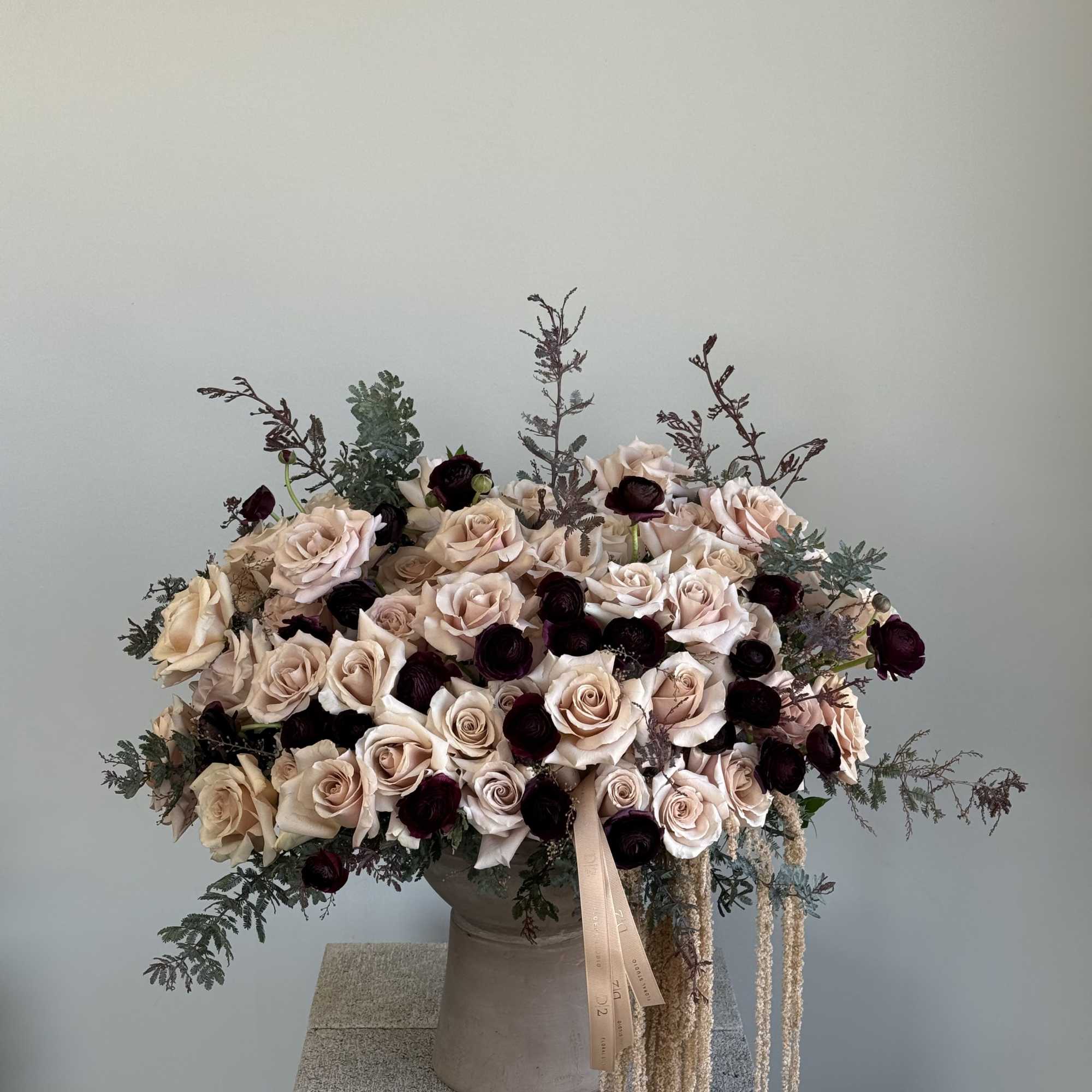 Large bouquet of blush and cream roses in a vase