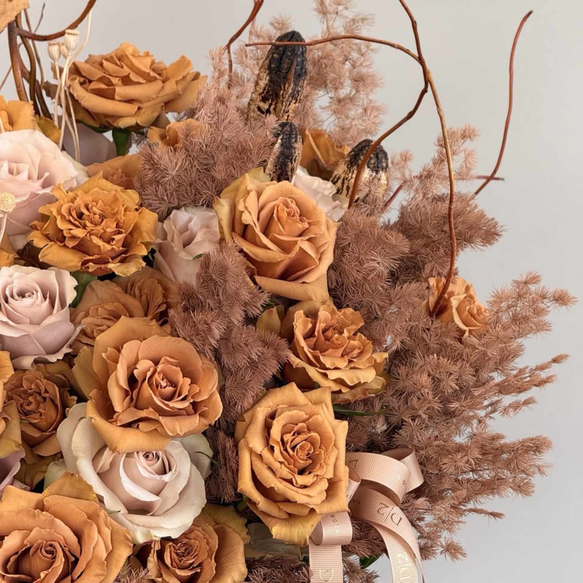 Bouquet of peach and blush roses with airy dried filler