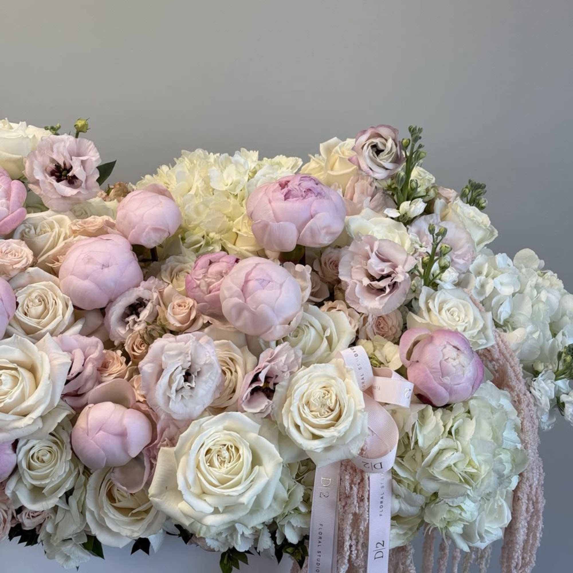 Large pastel bouquet of white roses, pink peonies, and hydrangeas