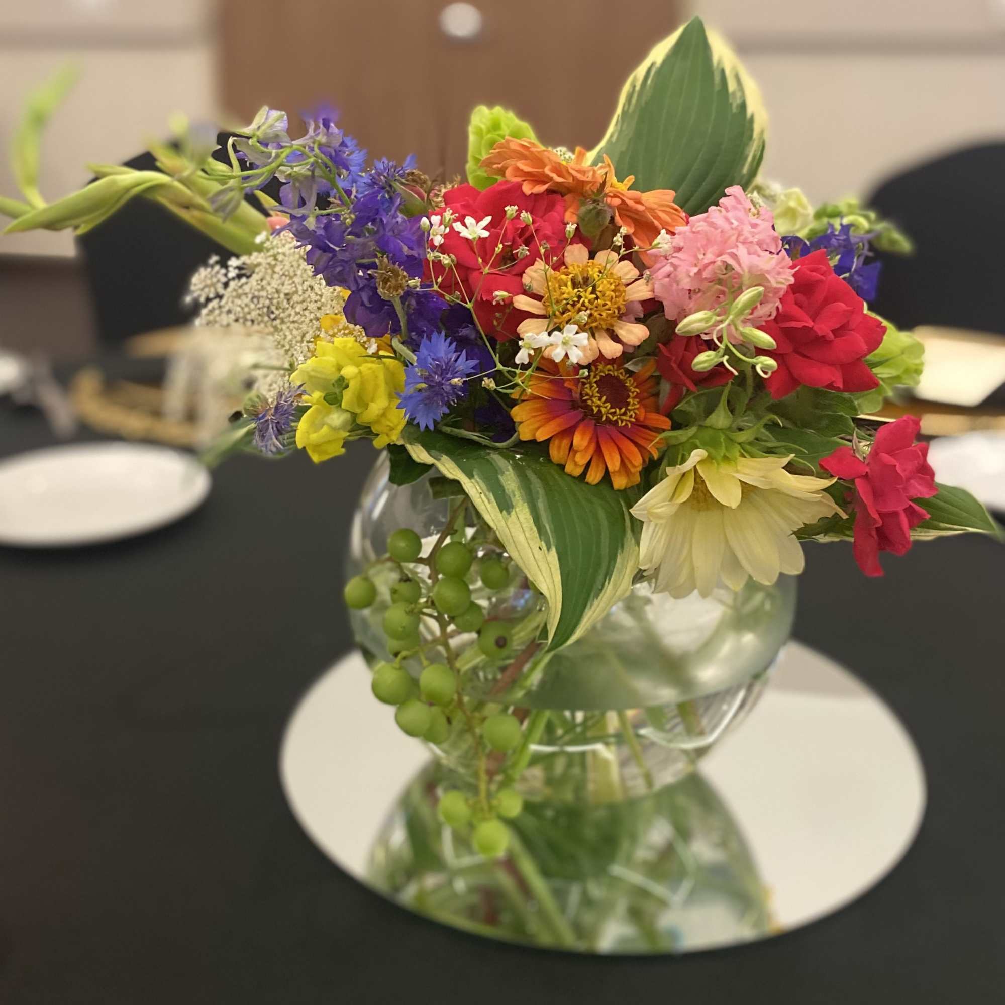 Colorful mixed bouquet in a clear glass vase on a table