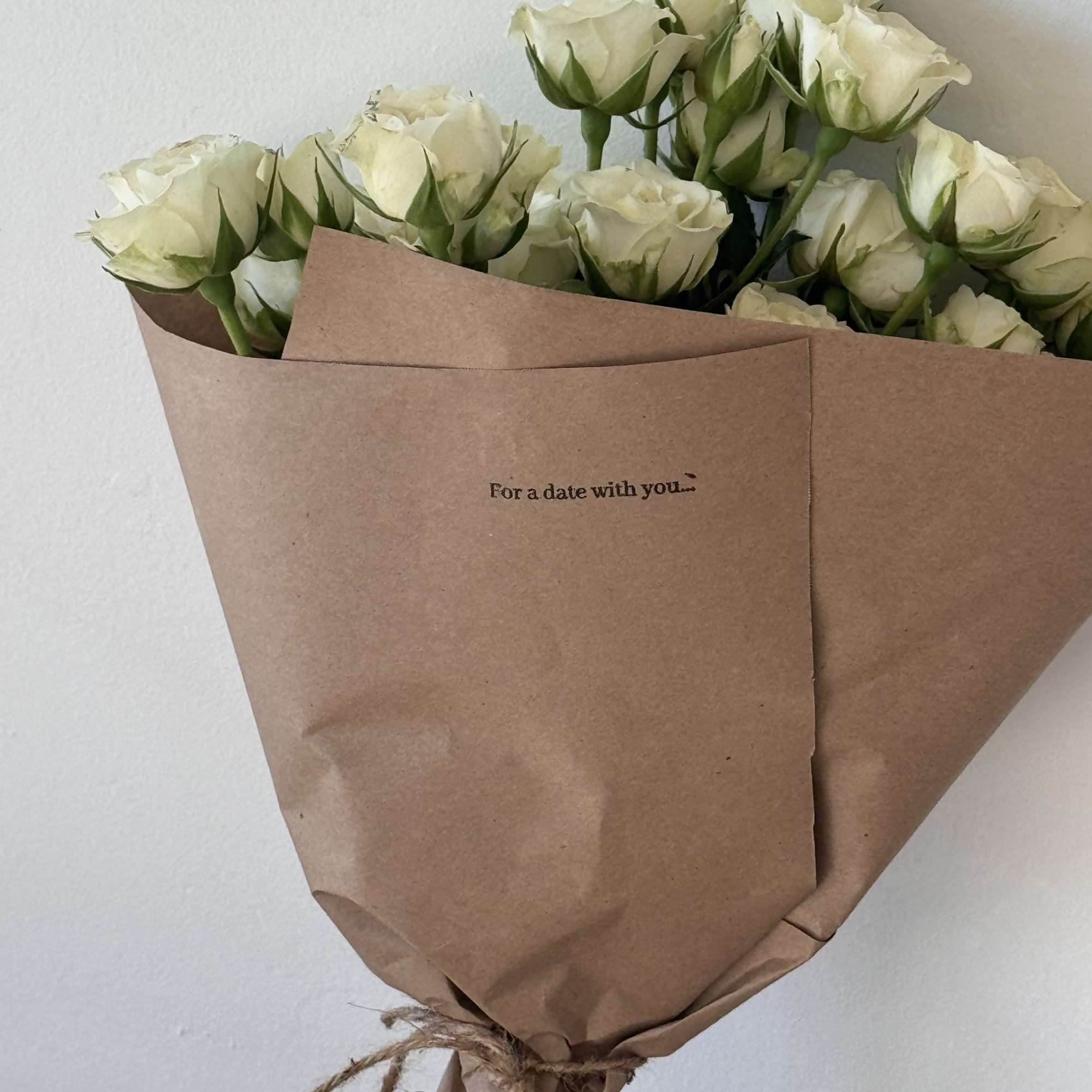 Bouquet of white roses wrapped in brown paper, photo 2 of 2