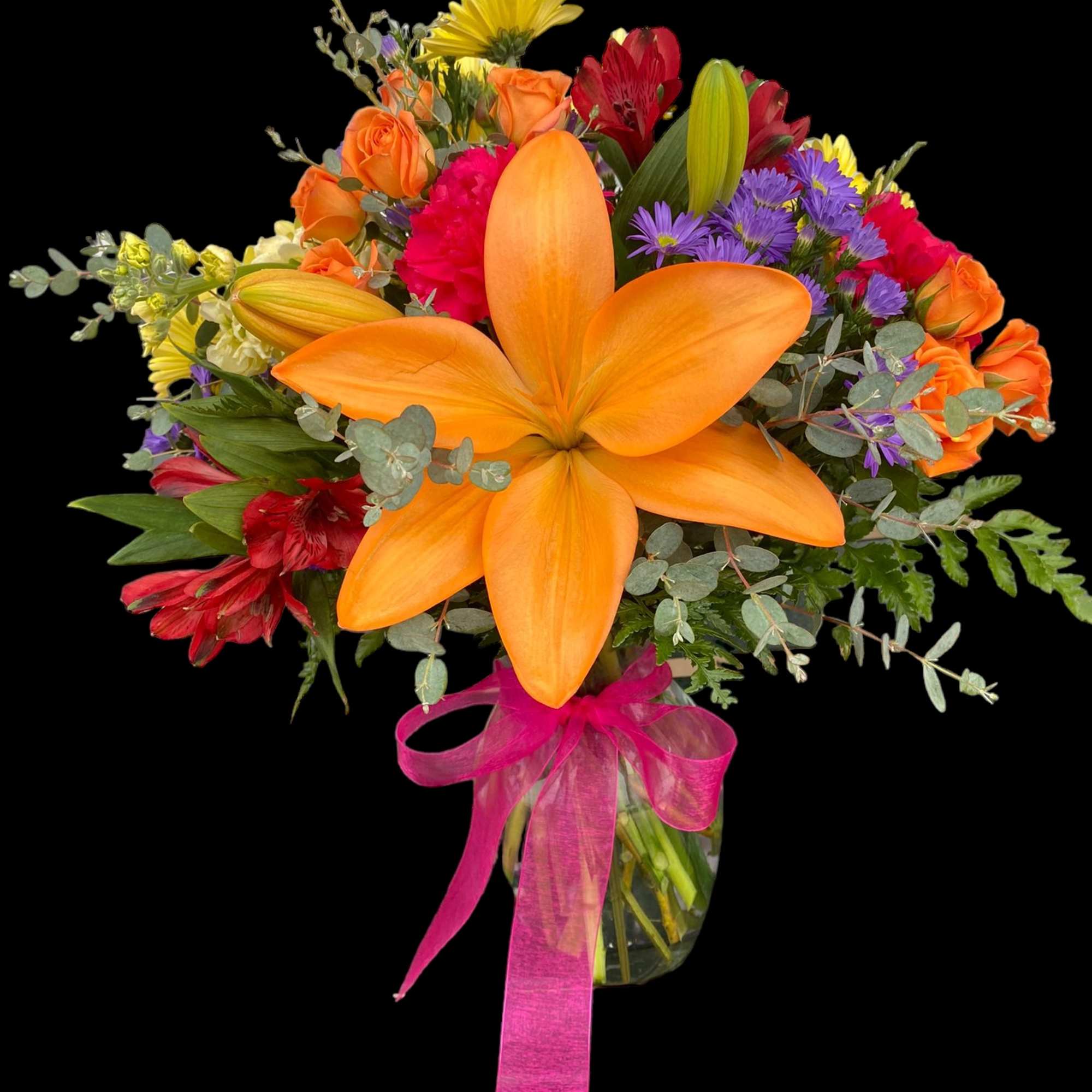 Colorful bouquet with orange lilies, roses, and purple flowers in a glass vase