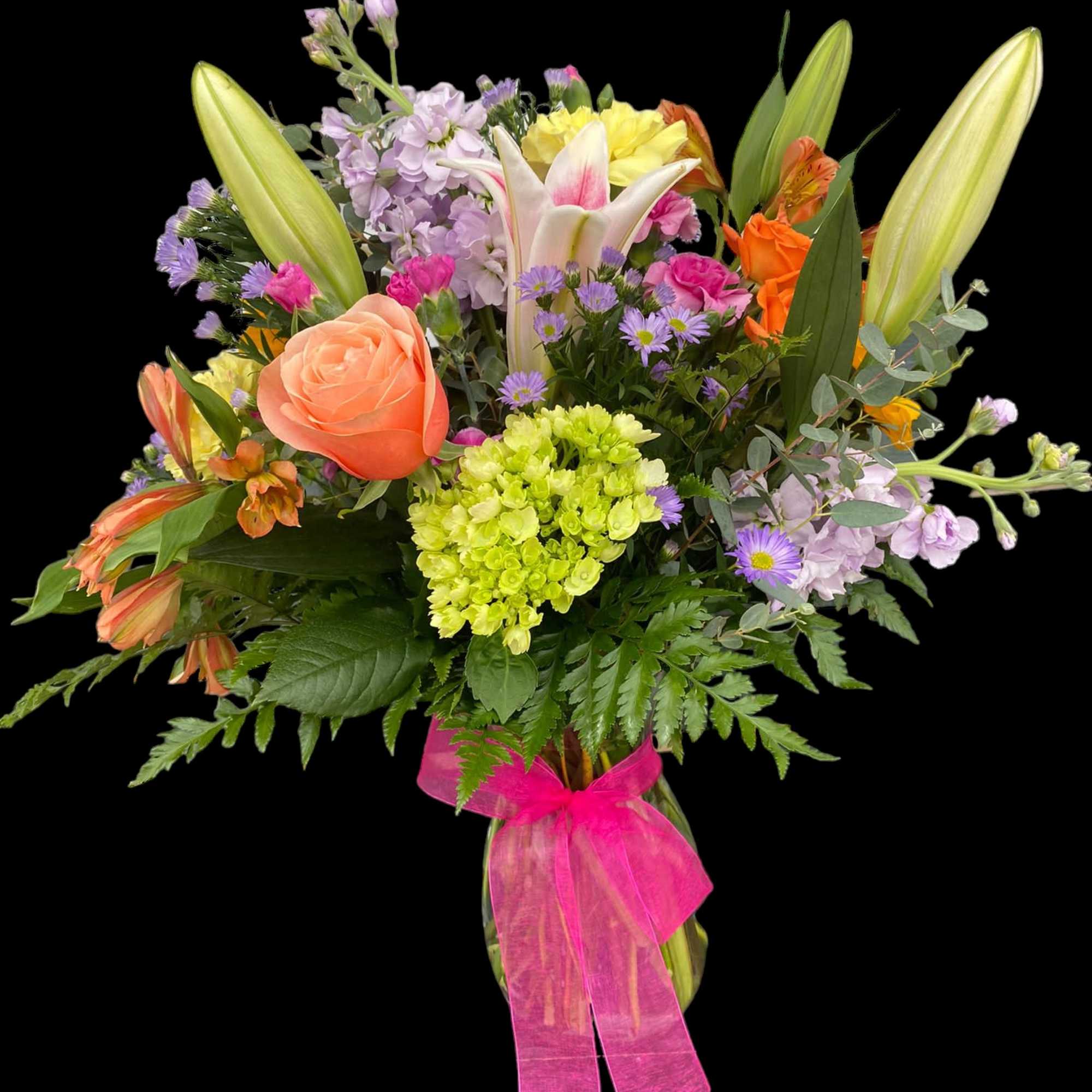 Mixed bouquet with lilies, roses, and pastel flowers tied with a pink ribbon
