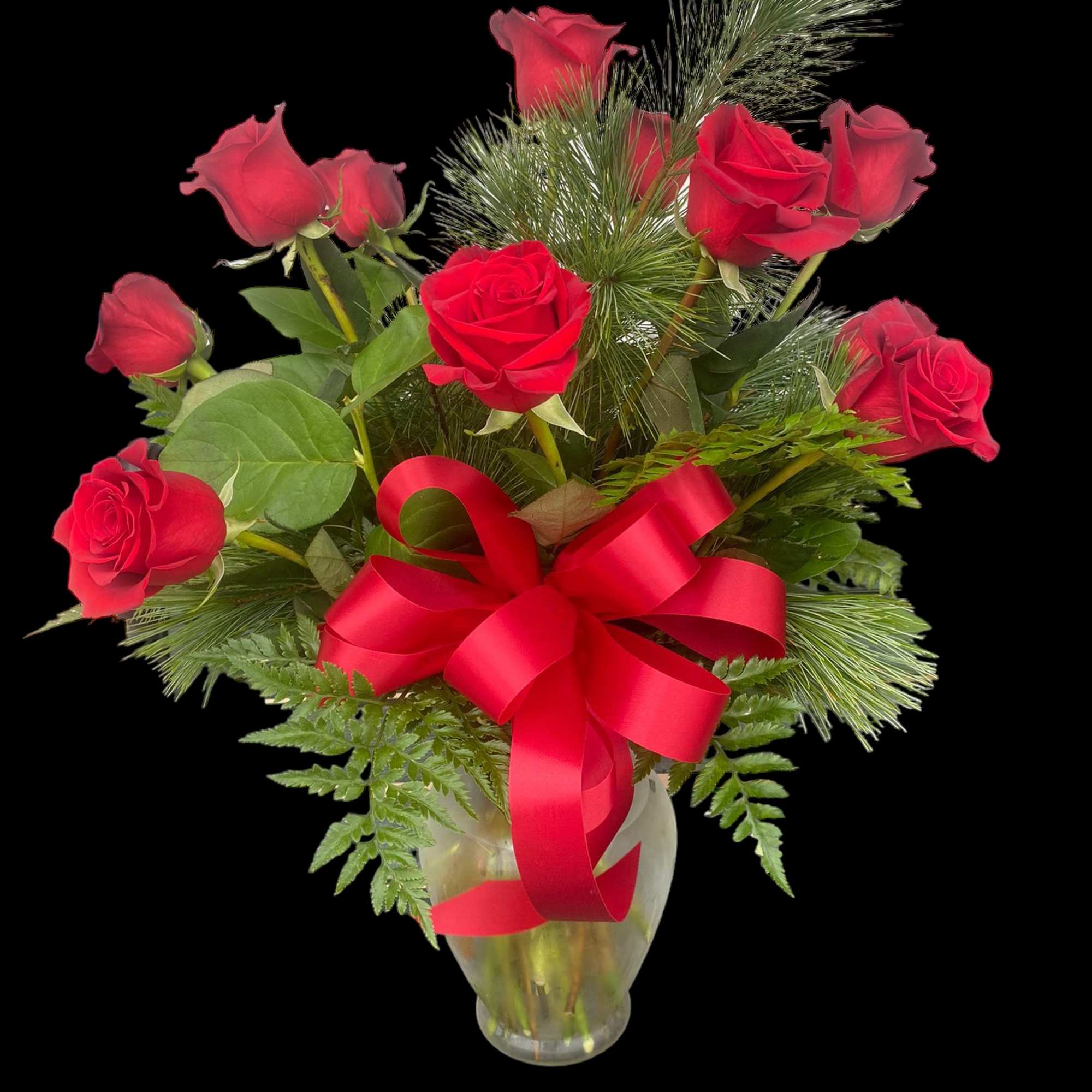 Red roses arranged in a clear glass vase with a red ribbon bow