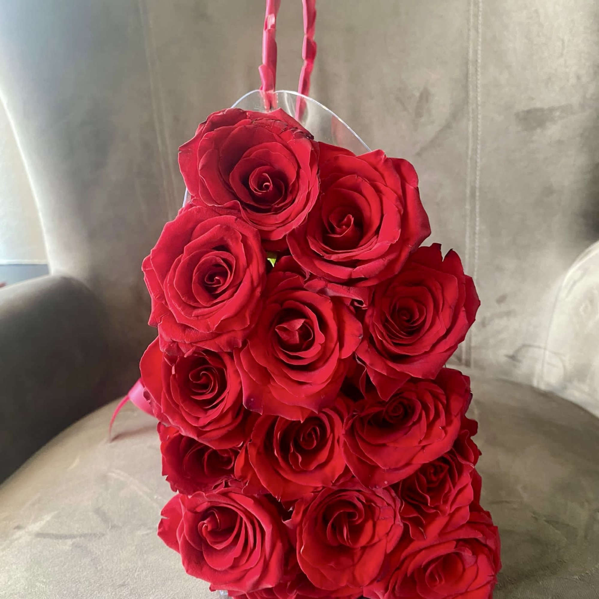 Red rose arrangement in a clear handled container