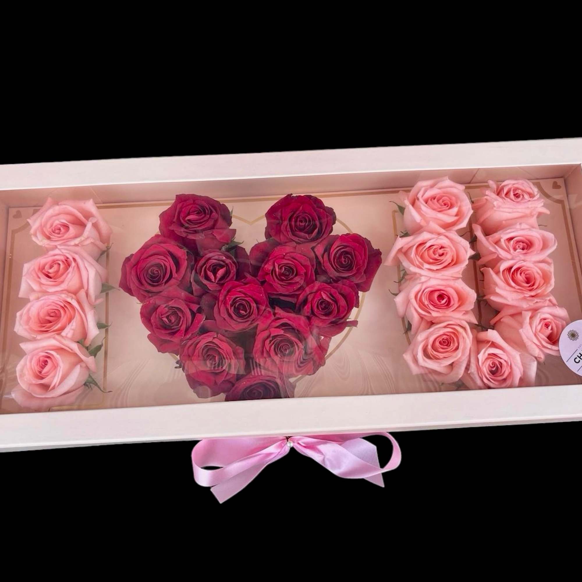Heart-shaped rose arrangement in a white gift box with pink ribbon