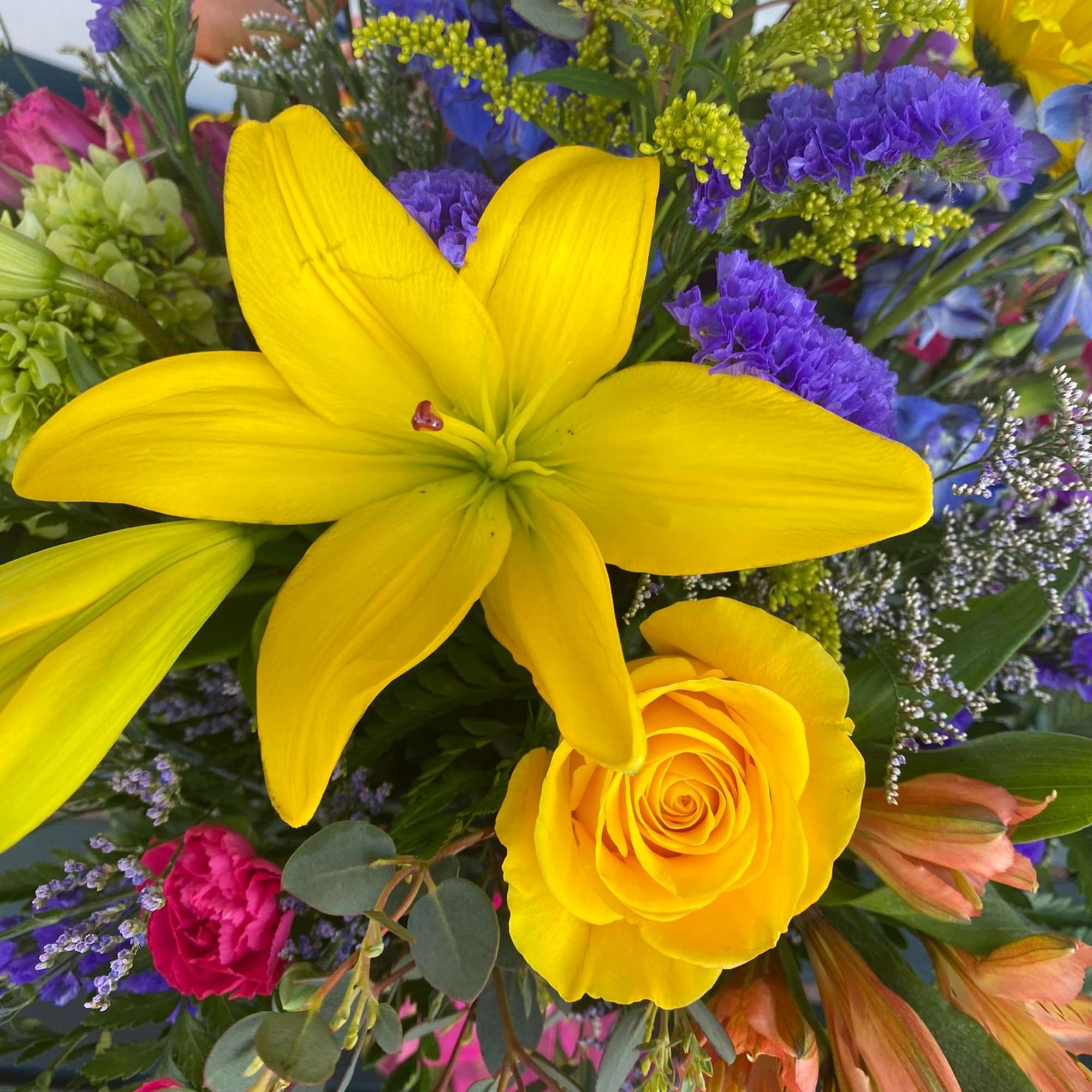 Bright mixed bouquet with yellow lilies and a yellow rose