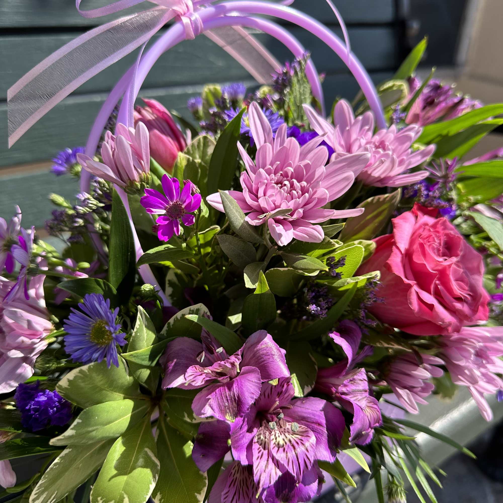Pink and purple mixed bouquet with a ribbon handle