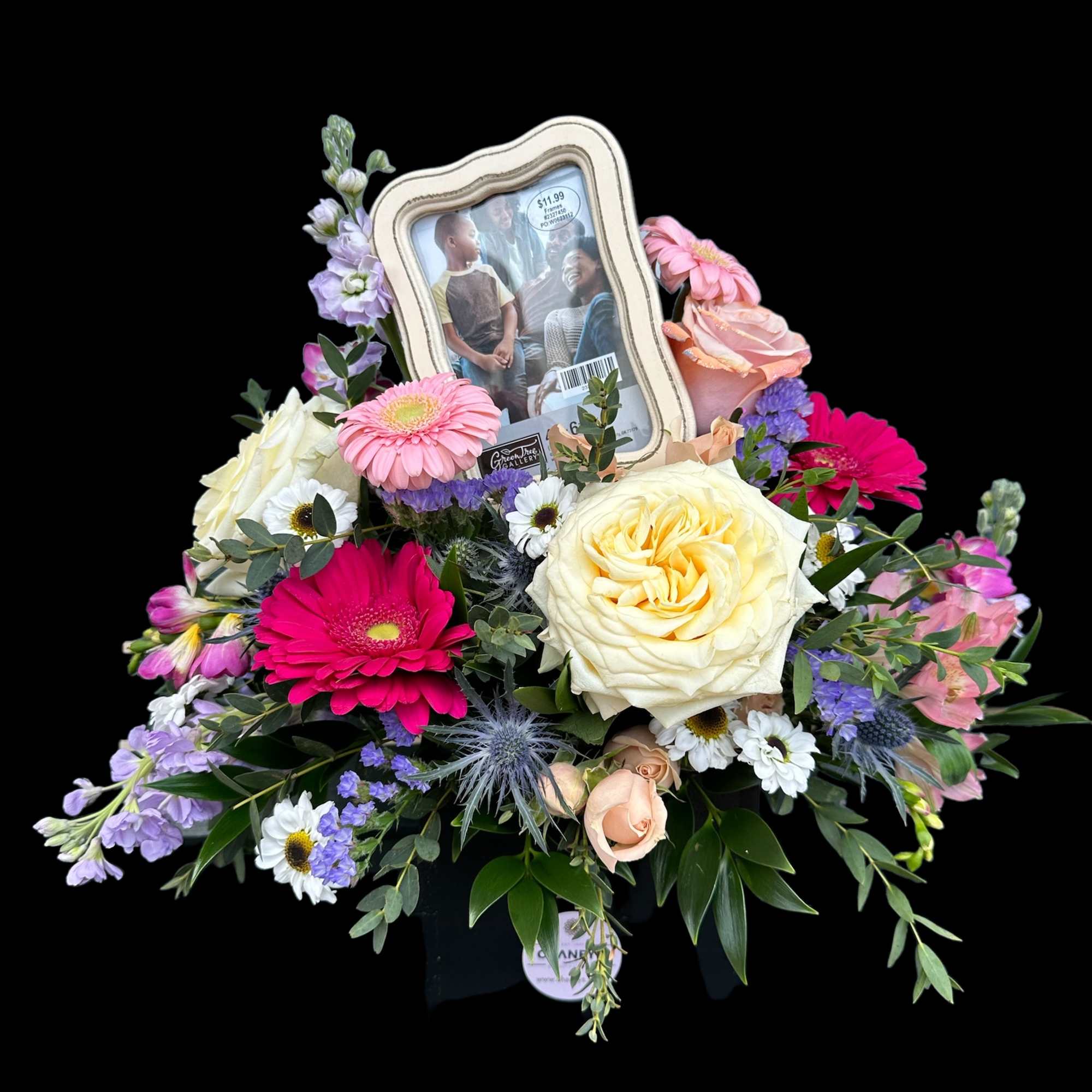 Mixed flower arrangement with a framed photo centerpiece
