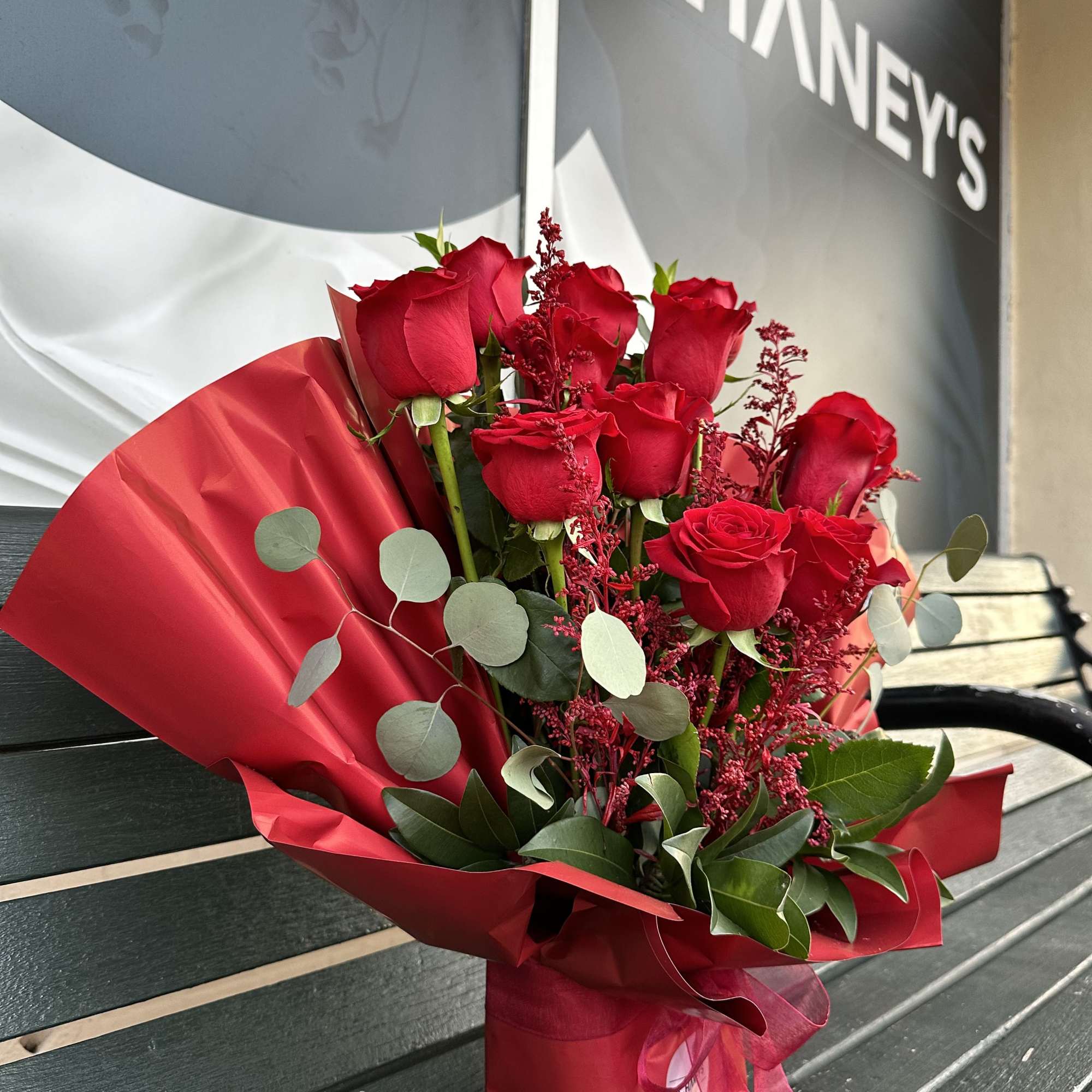 Bouquet of red roses wrapped in red paper, photo 2 of 7