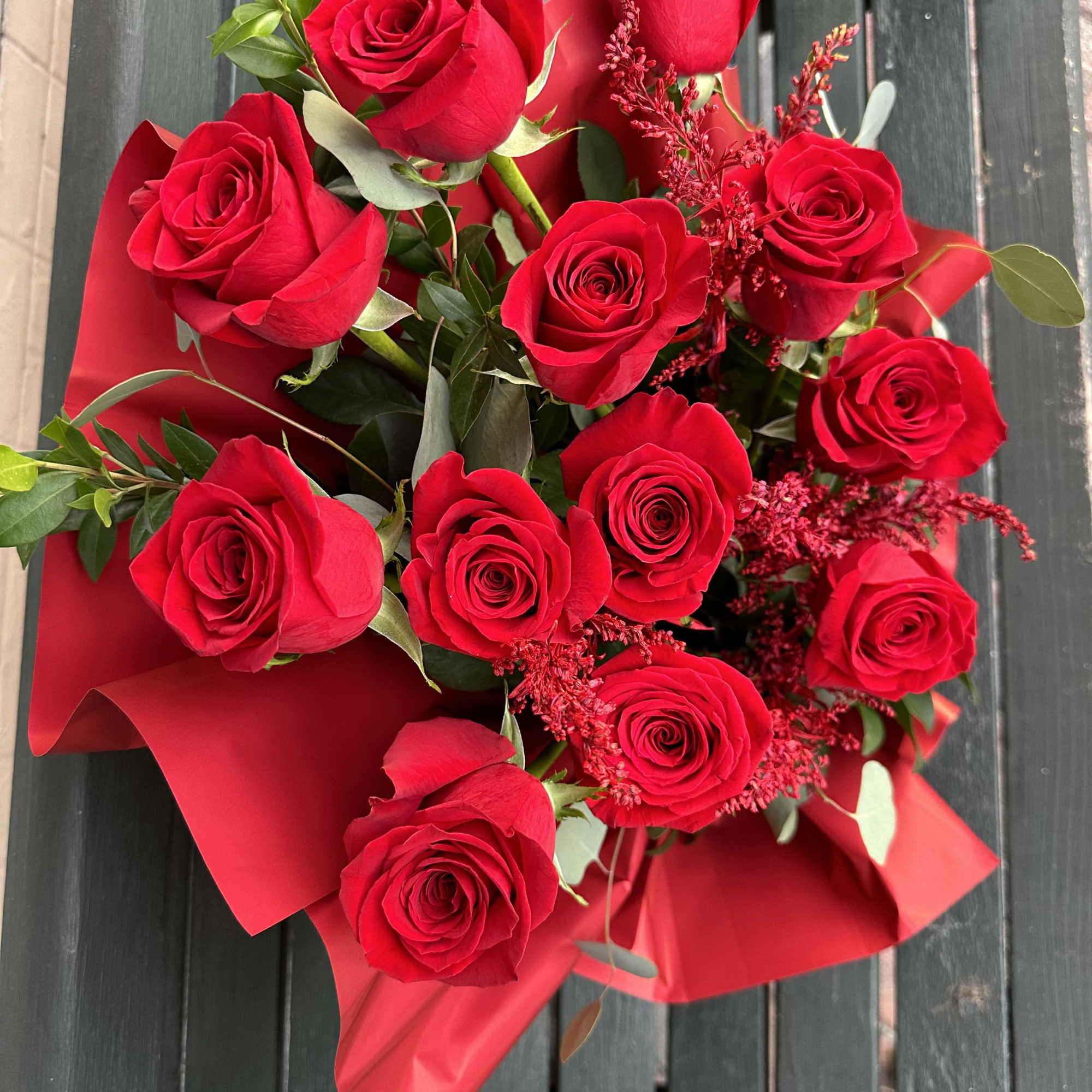 Bouquet of red roses wrapped in red paper, photo 7 of 7