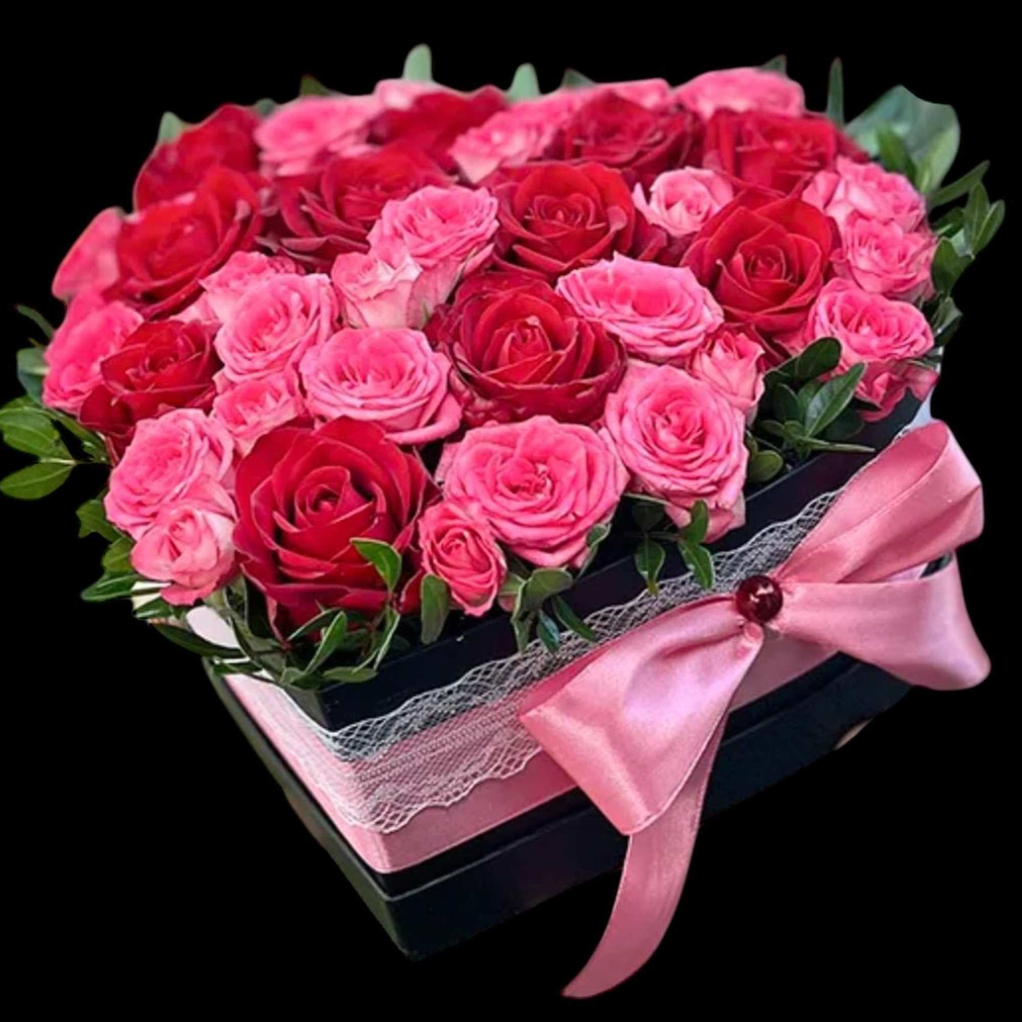 Pink and red roses in a black gift box with a pink ribbon