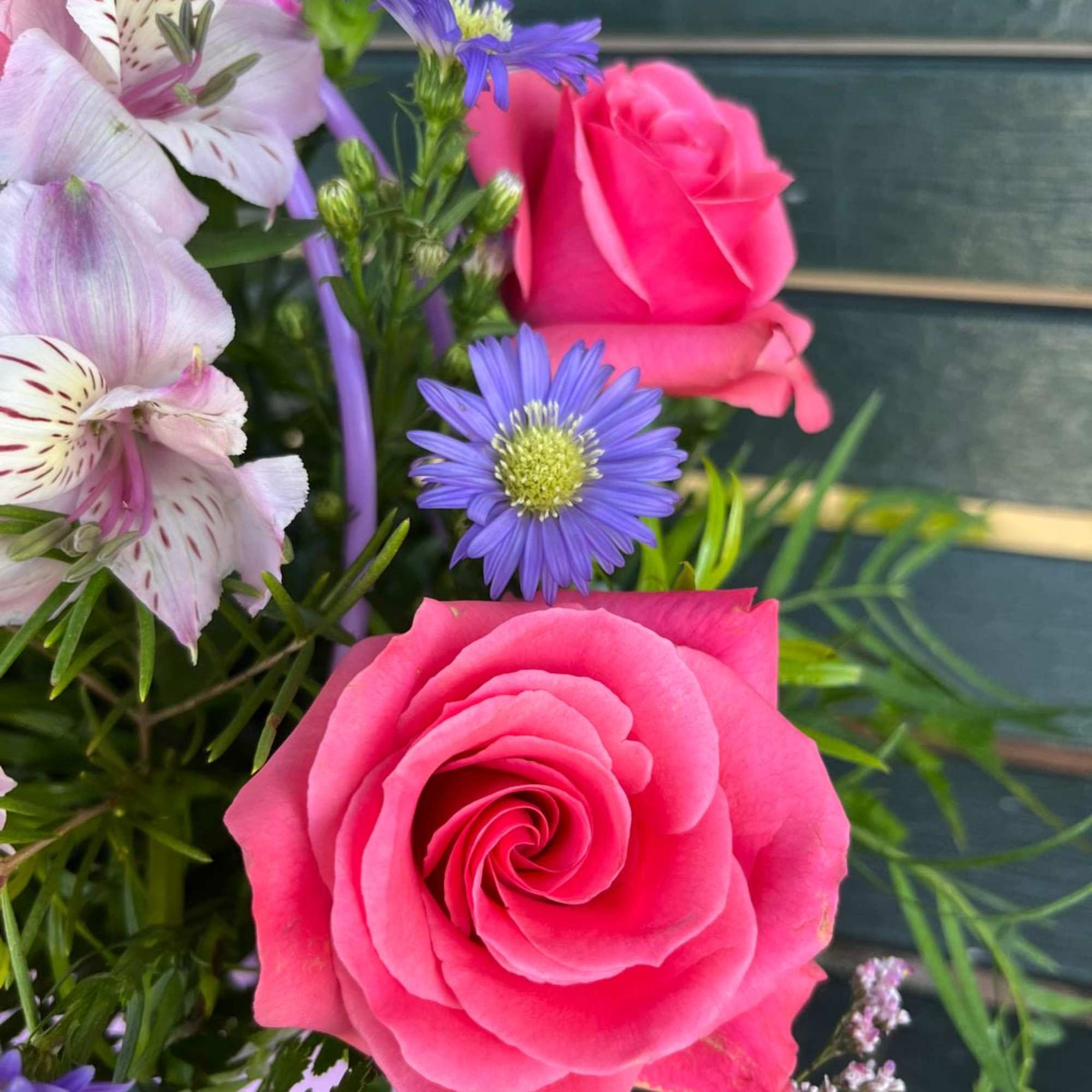 Pink roses and purple flowers in a bouquet
