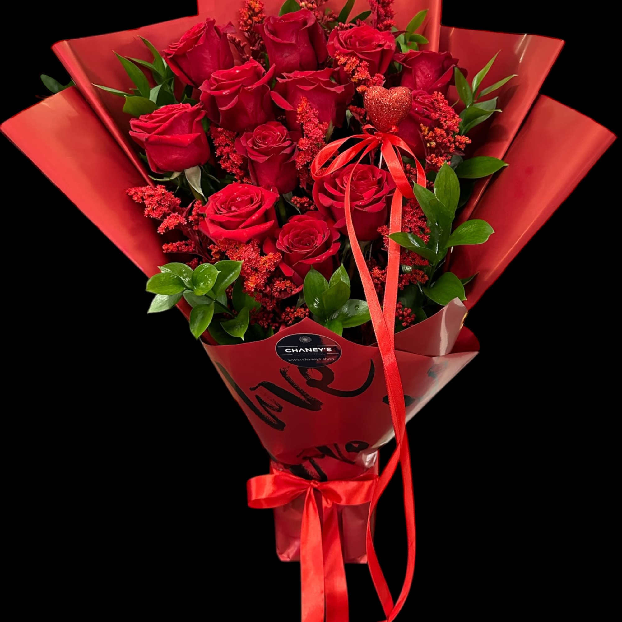 Bouquet of red roses wrapped in red paper with a ribbon