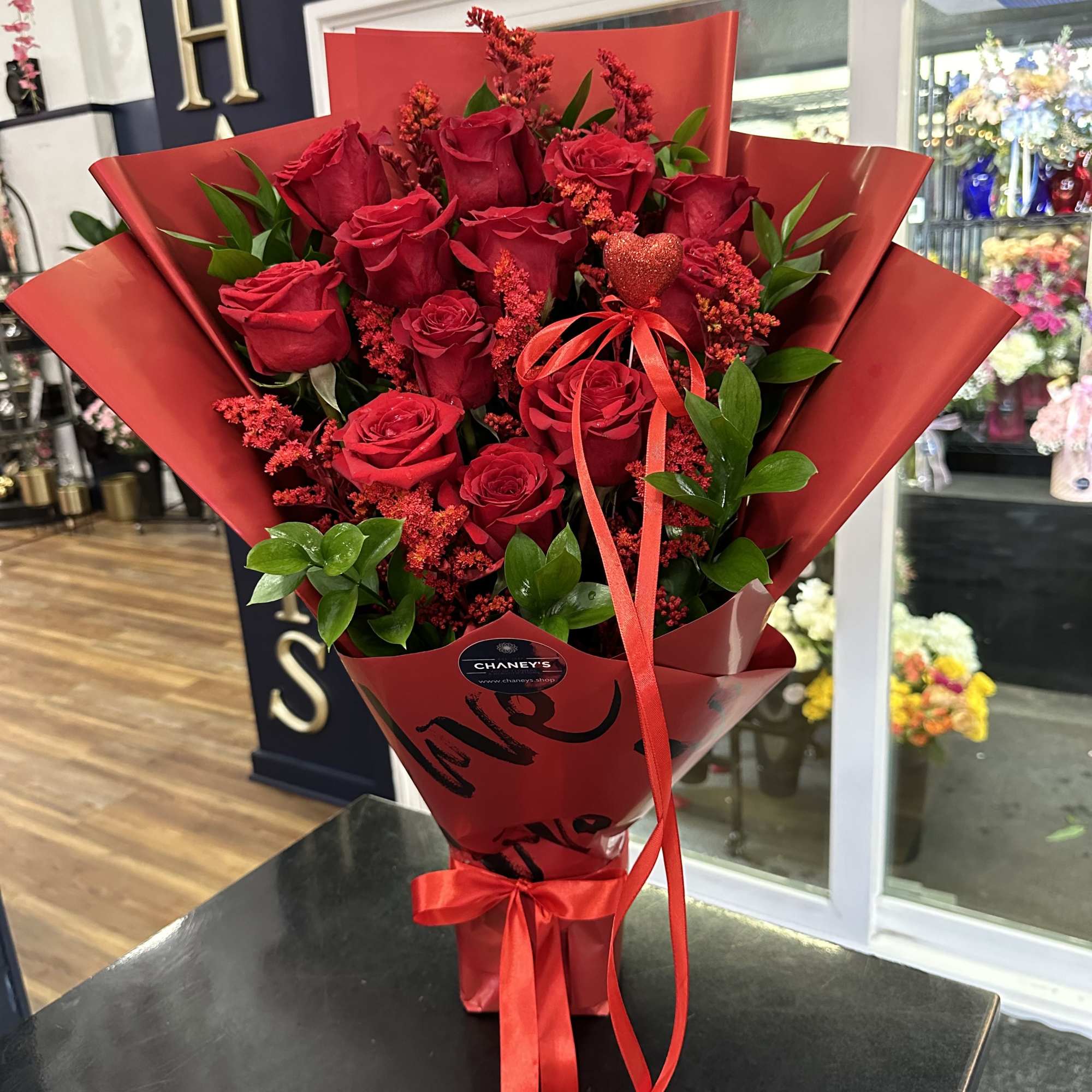 Bouquet of red roses wrapped in red paper with a ribbon, photo 5 of 5