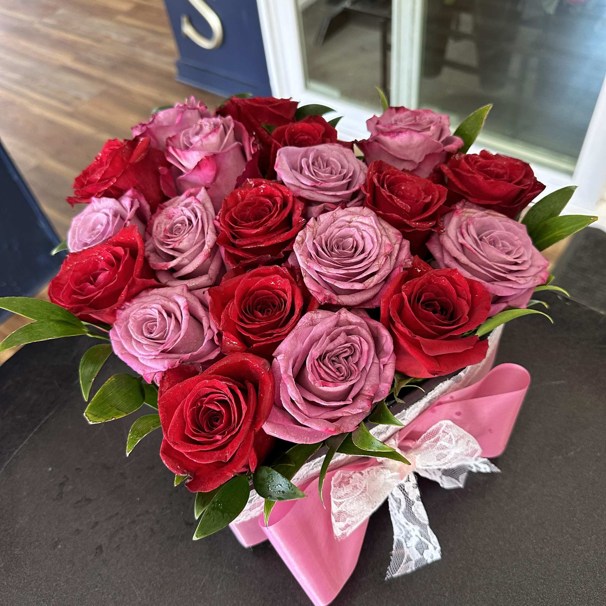 Bouquet of red and pink roses with a pink ribbon wrap