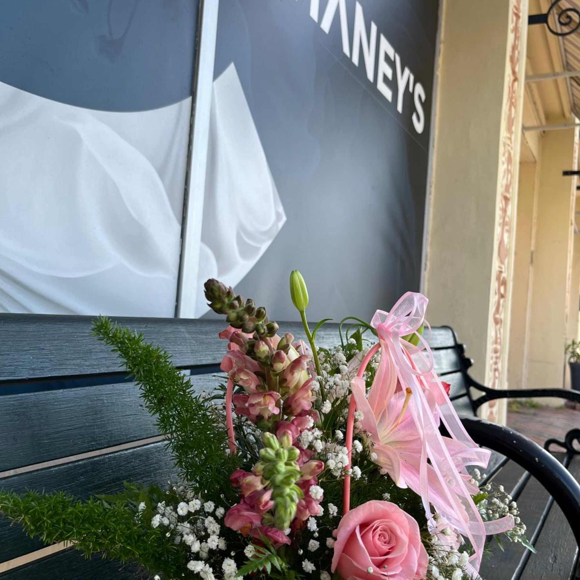 Pink rose and snapdragon arrangement in a pink box with ribbon
