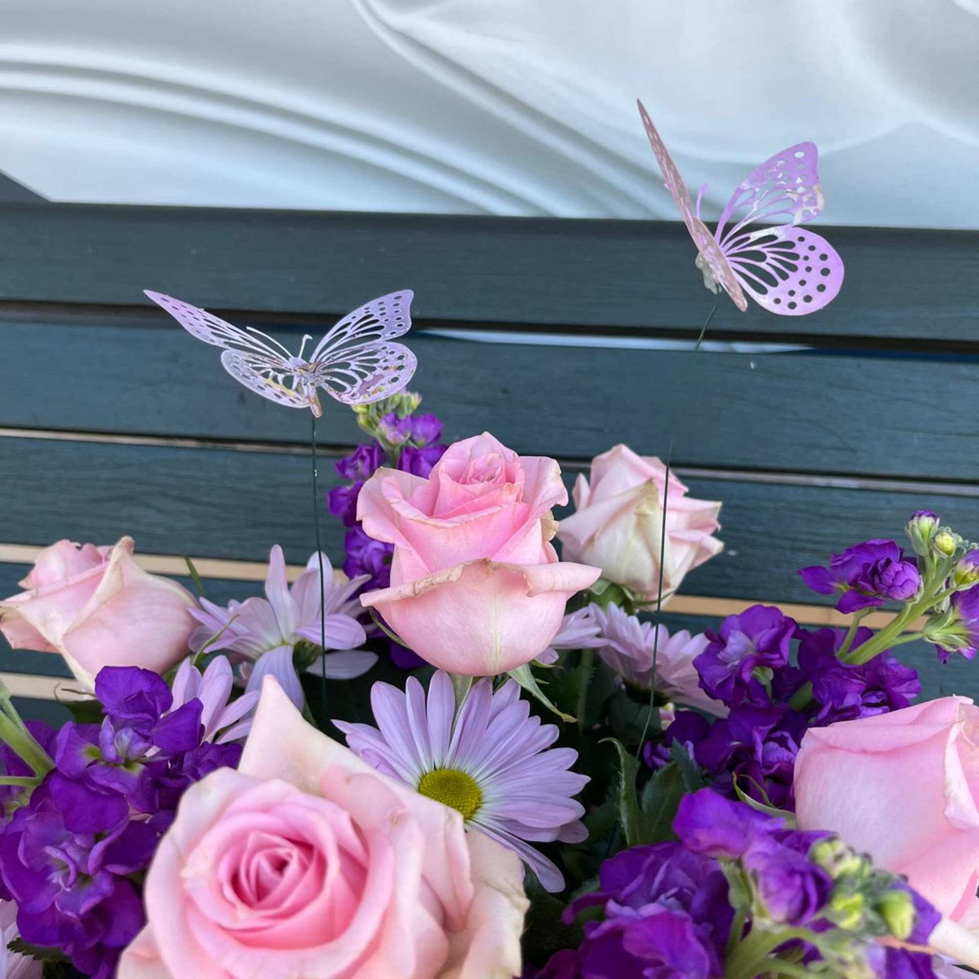 Pink roses and purple daisies with butterfly picks