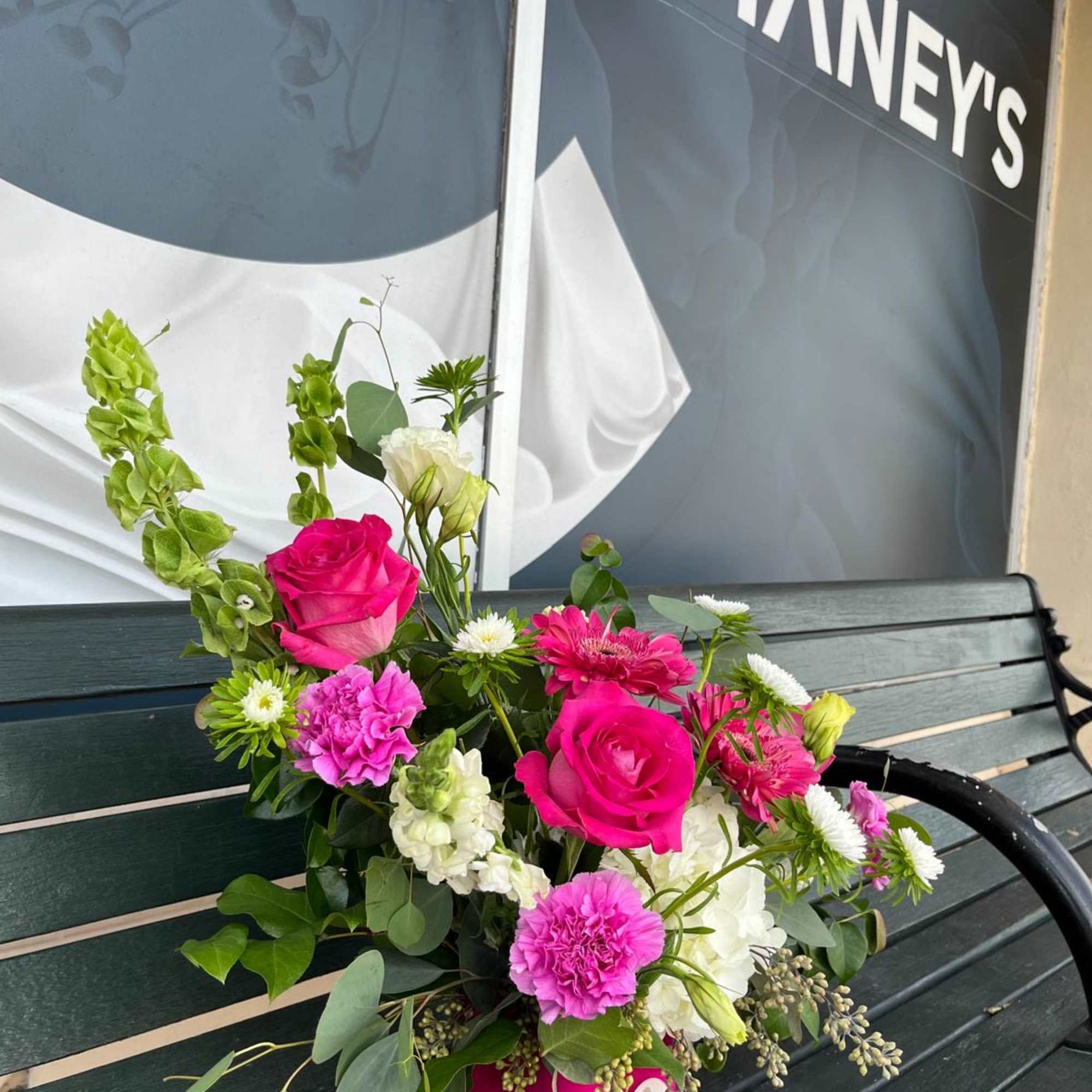 Bright pink and white mixed flower arrangement in a magenta vase
