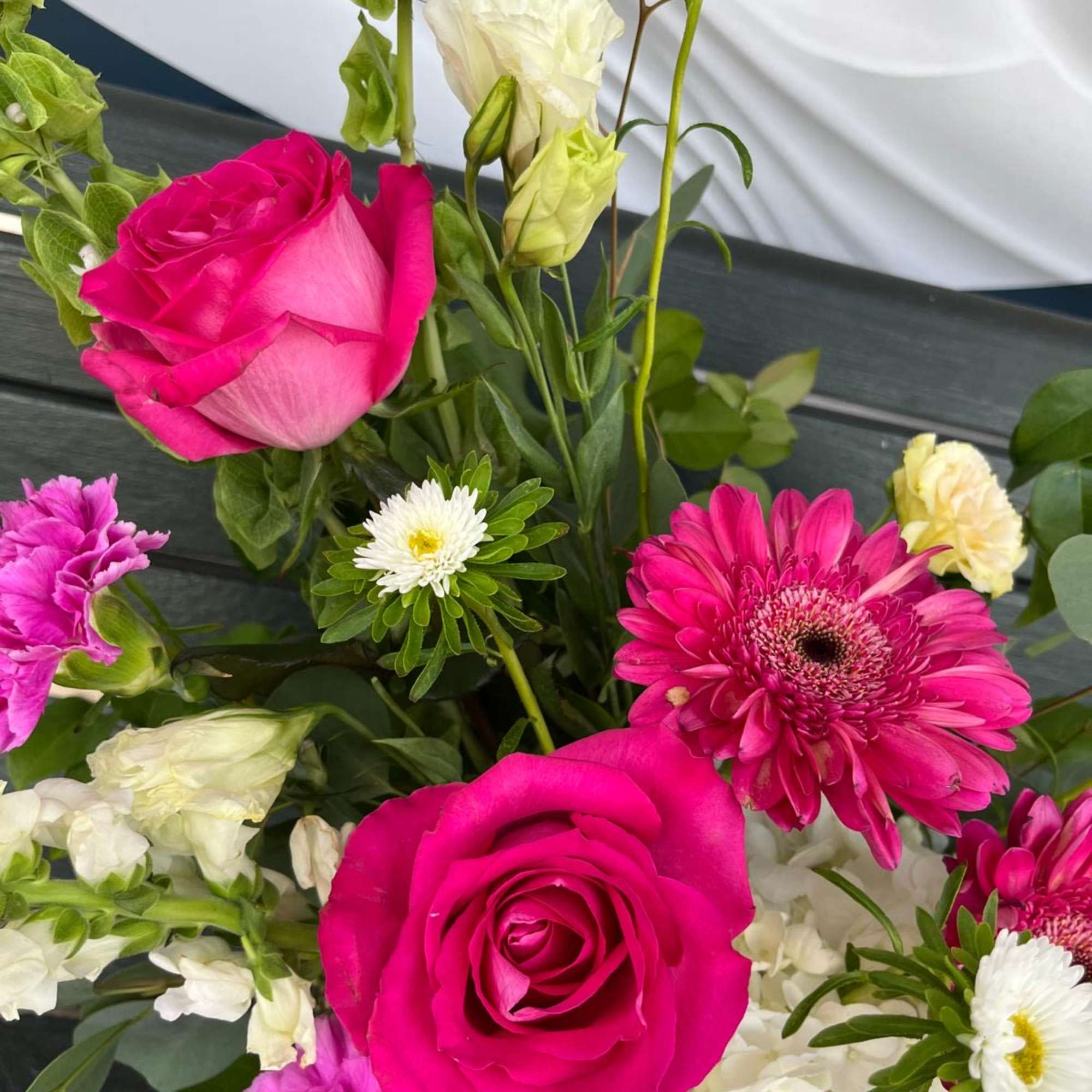 Bouquet of hot pink roses, gerbera daisies, and white flowers