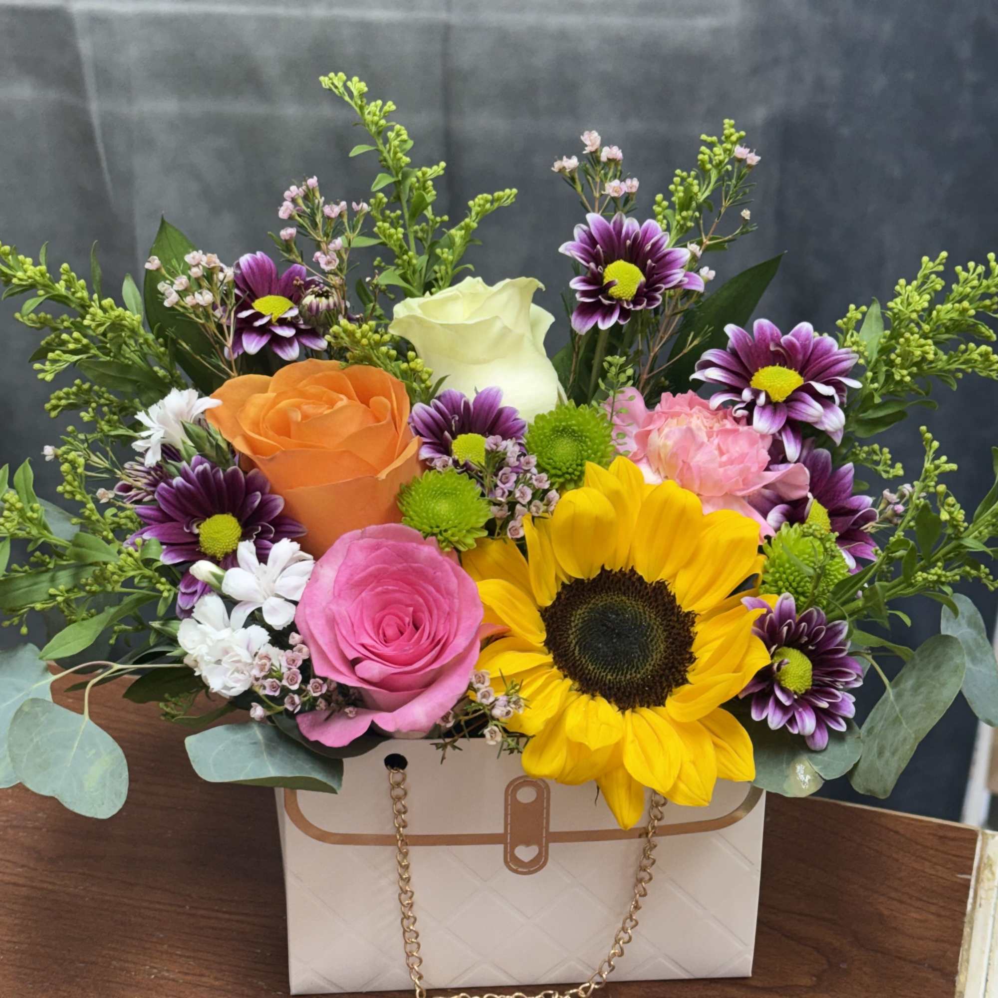 Sunflower-centered mixed  with pink, orange, purple and cream blooms in a, photo 2 of 2