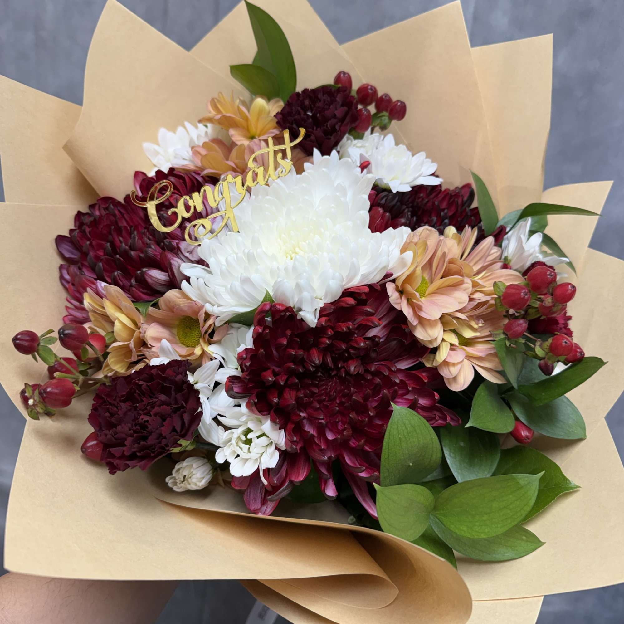 A rich and cheerful mix of burgundy chrysanthemums, white mums, peach daisies