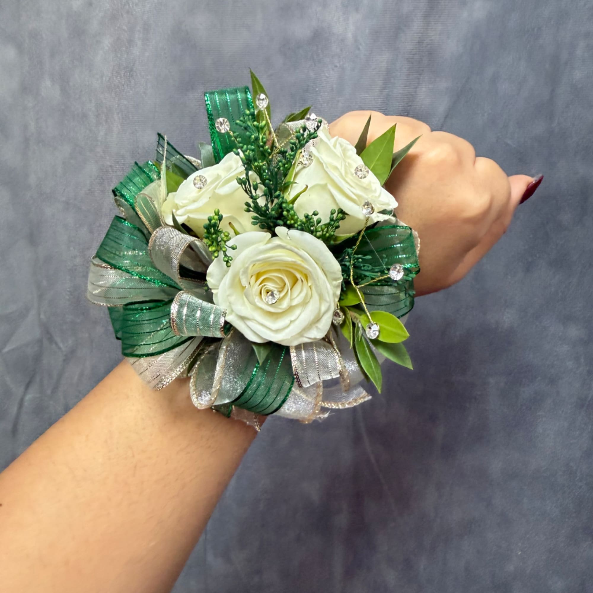 White rose wrist corsage with green and silver ribbon accents
