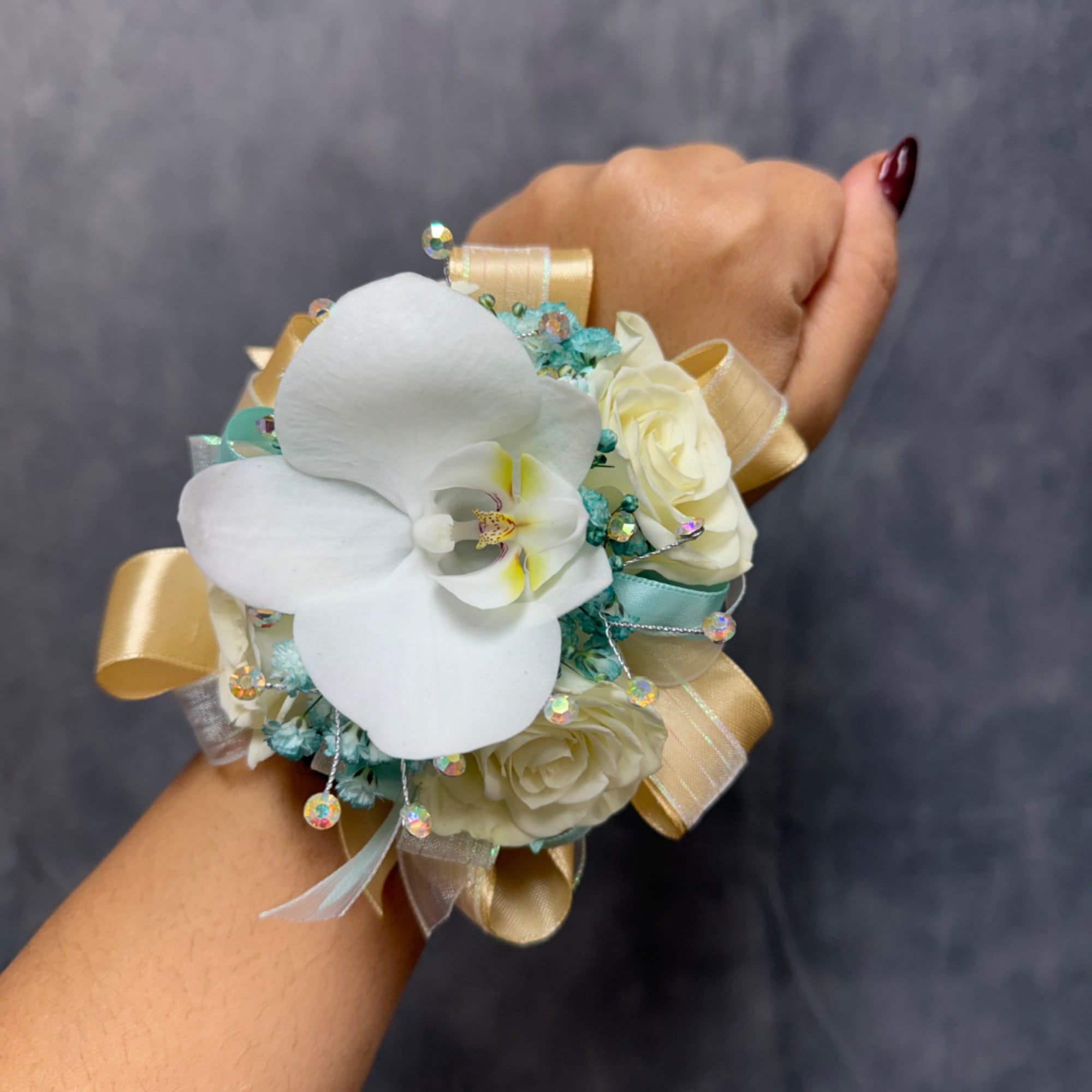 White orchid and cream rose wrist corsage with ribbon accents