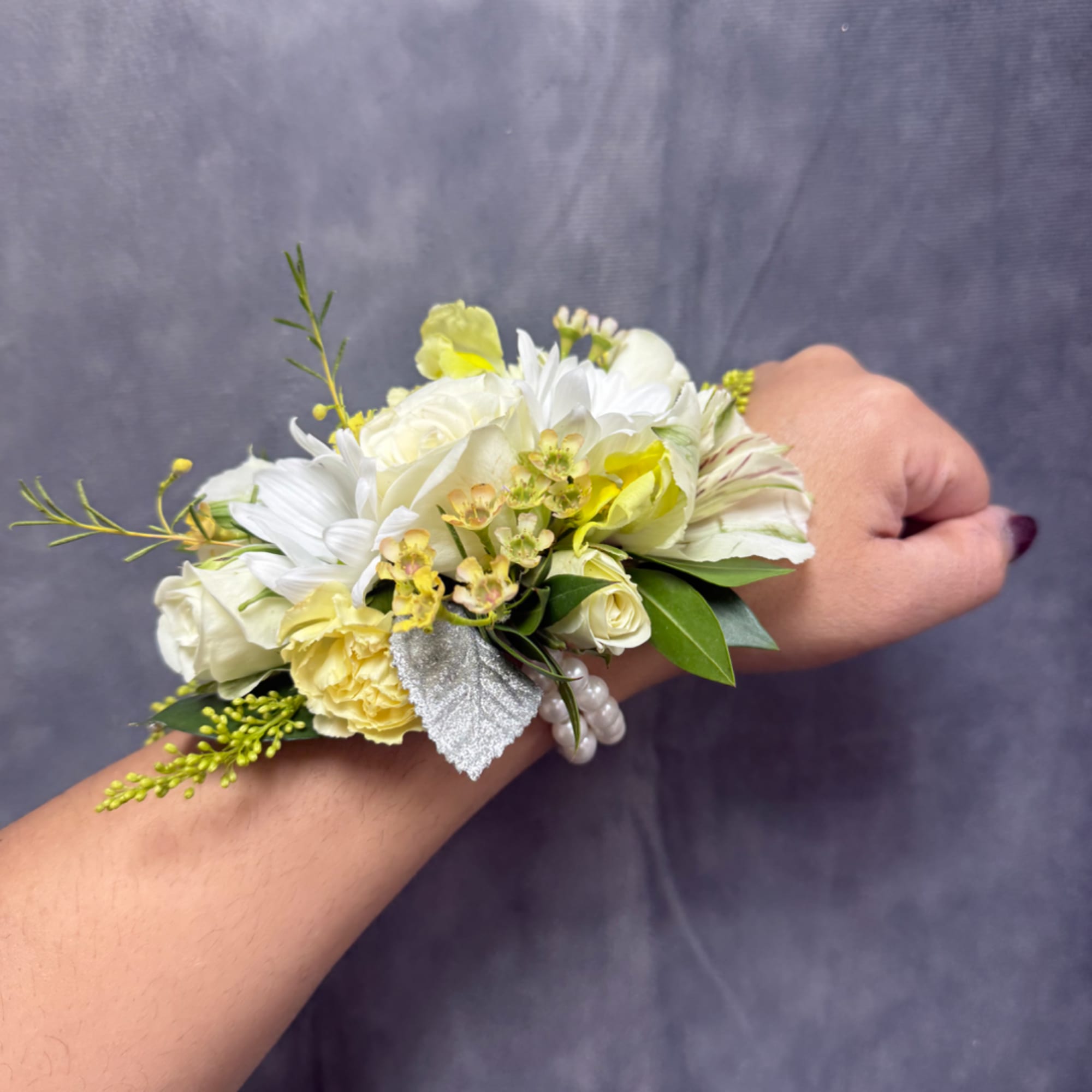 White and pale yellow wrist corsage with small flowers