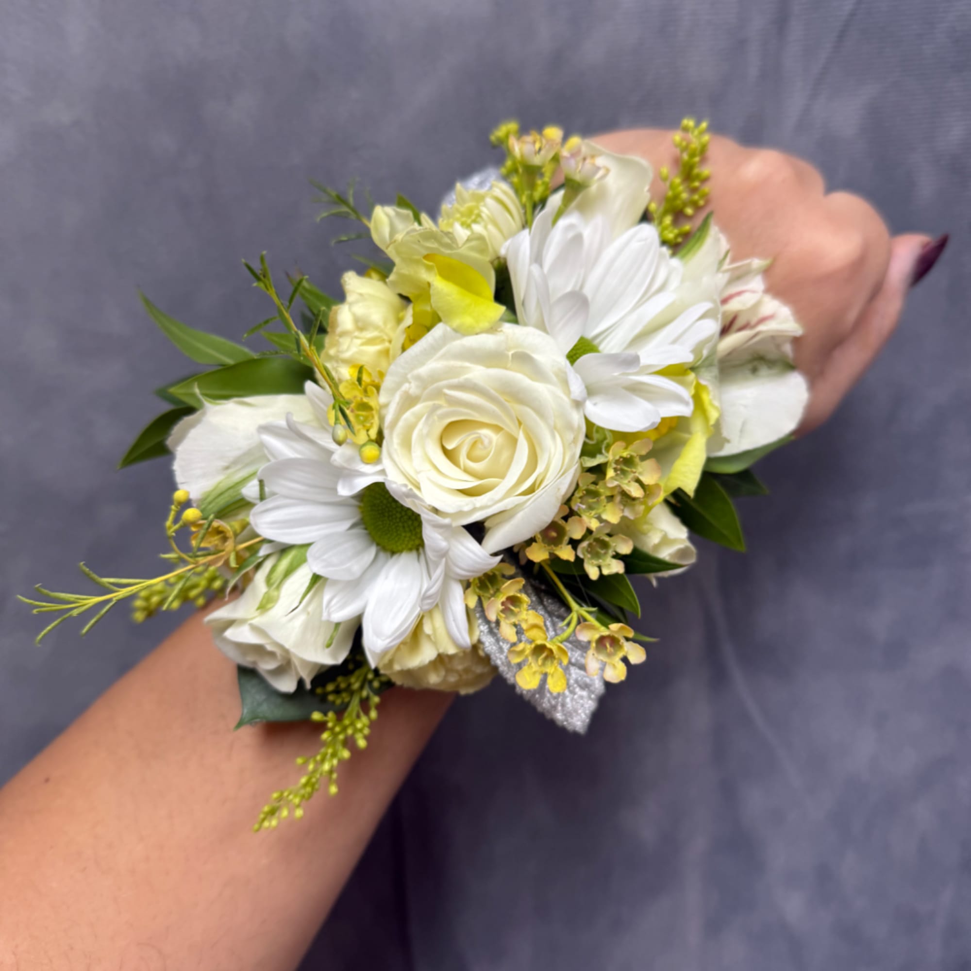 White rose and daisy wrist corsage with yellow accents