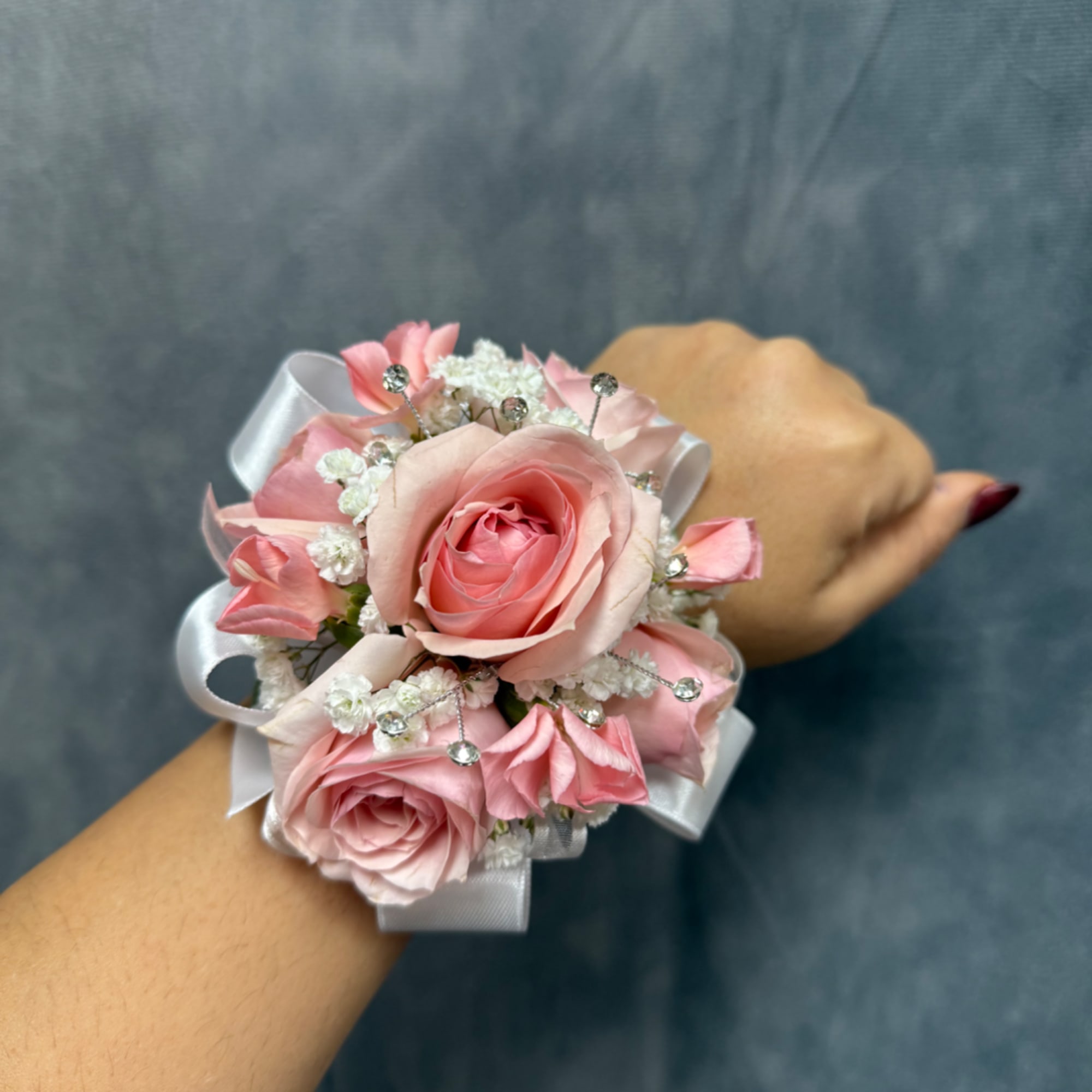 Pink rose wrist corsage with white ribbon and small crystal accents