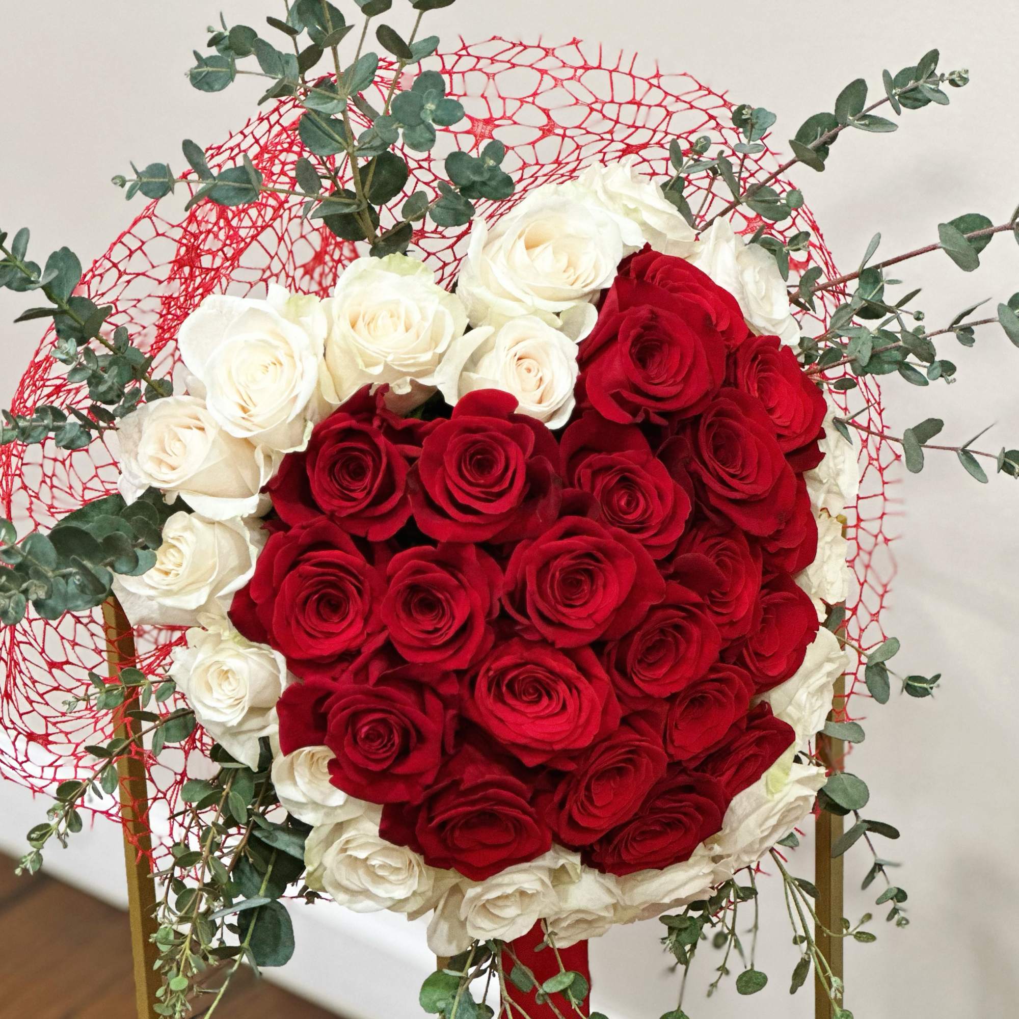 Red and White Rose Bouquet wrapped in a delicate red mesh and