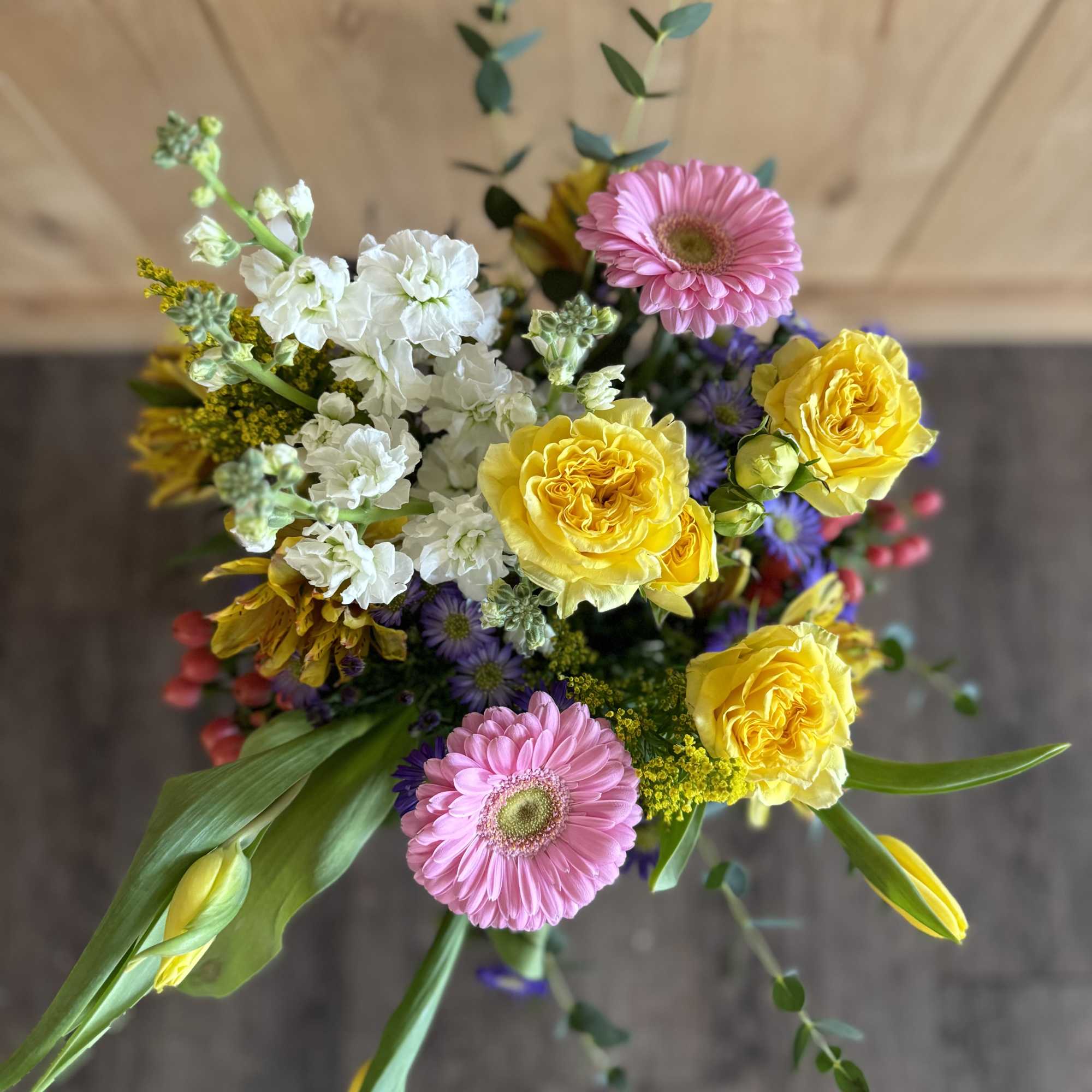 Bouquet with pink gerbera daisies, yellow roses, and white stock