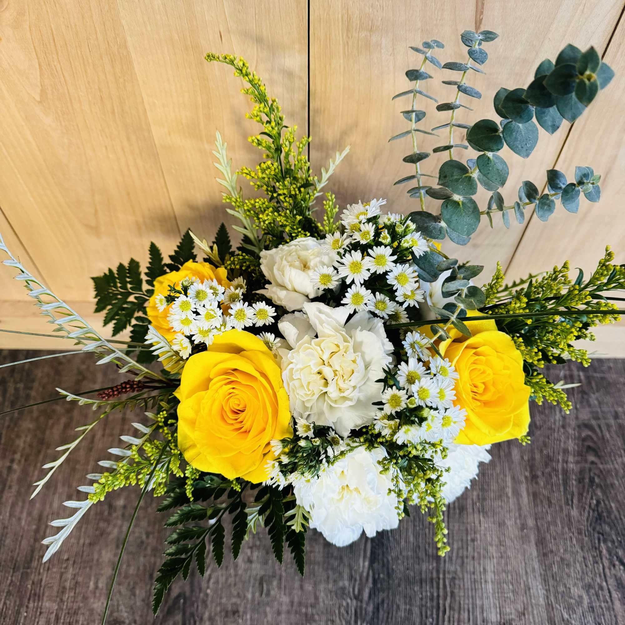 Yellow and white flower bouquet with daisies and eucalyptus