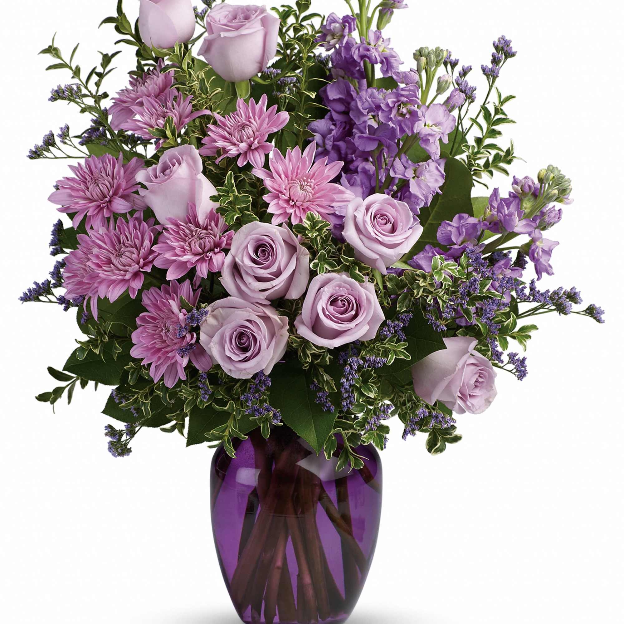 Lavender roses and purple flowers arranged in a purple glass vase.