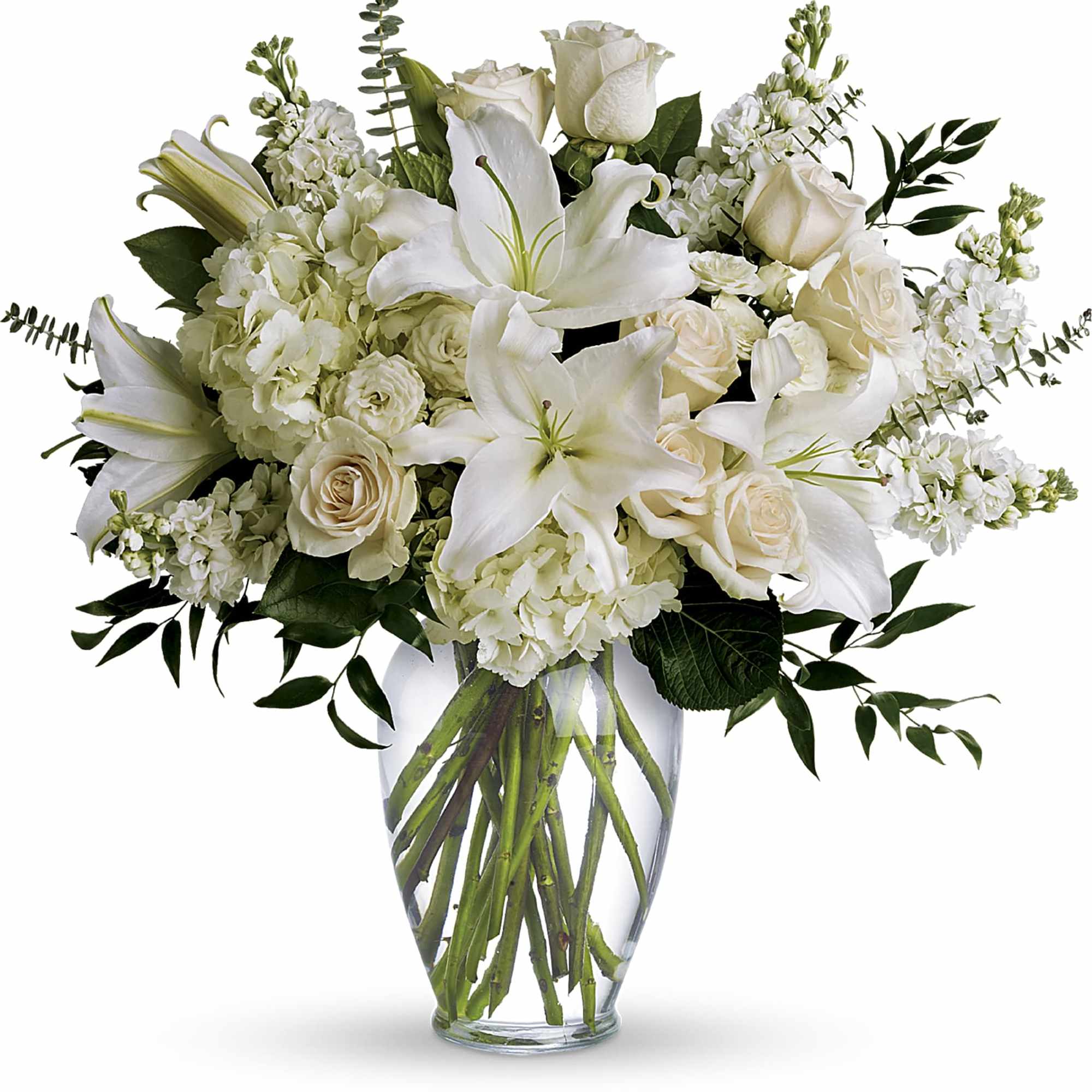 White lilies and roses arranged in a clear glass vase