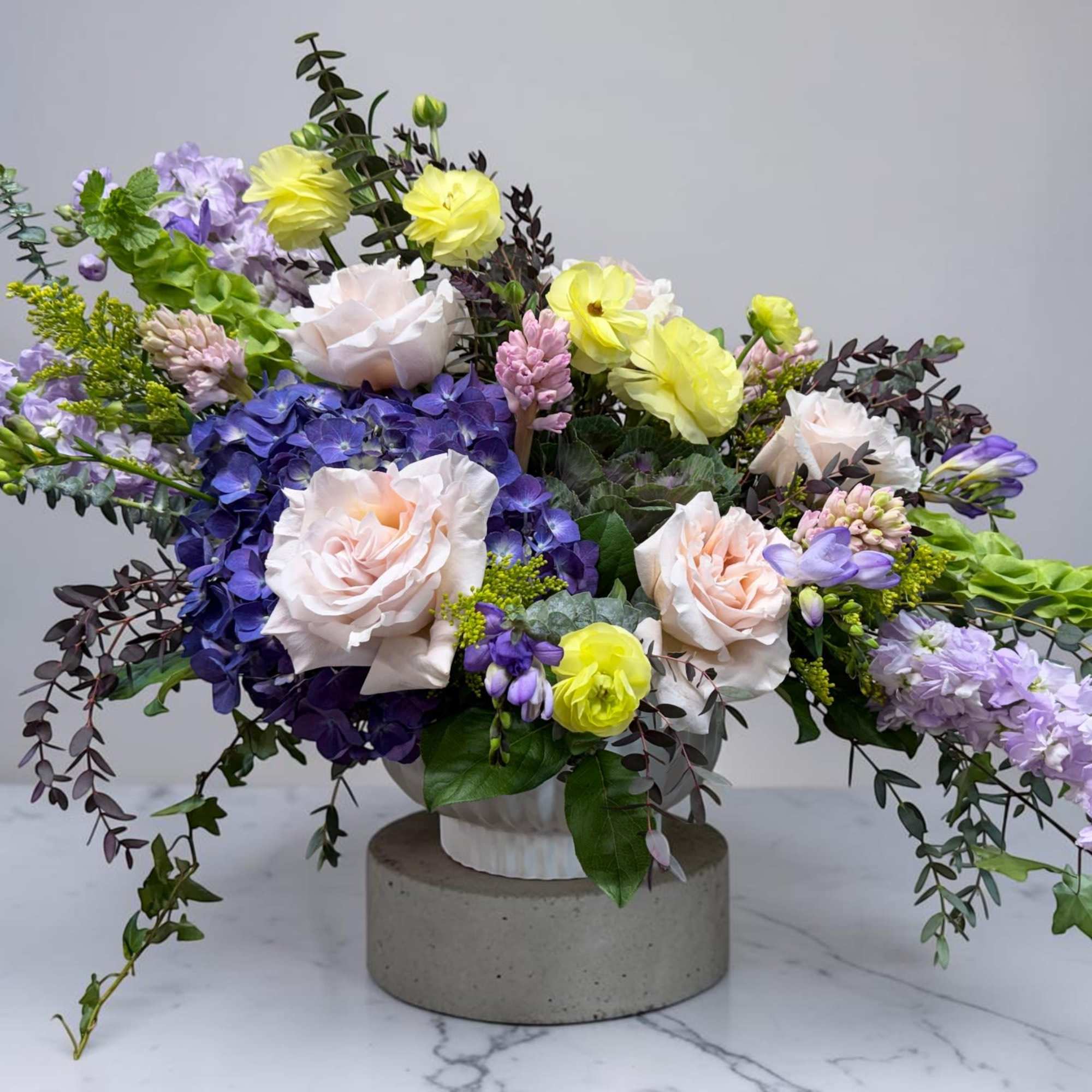 The Designer's Choice Compote Arrangement is an artistic and elegant arrangement of
