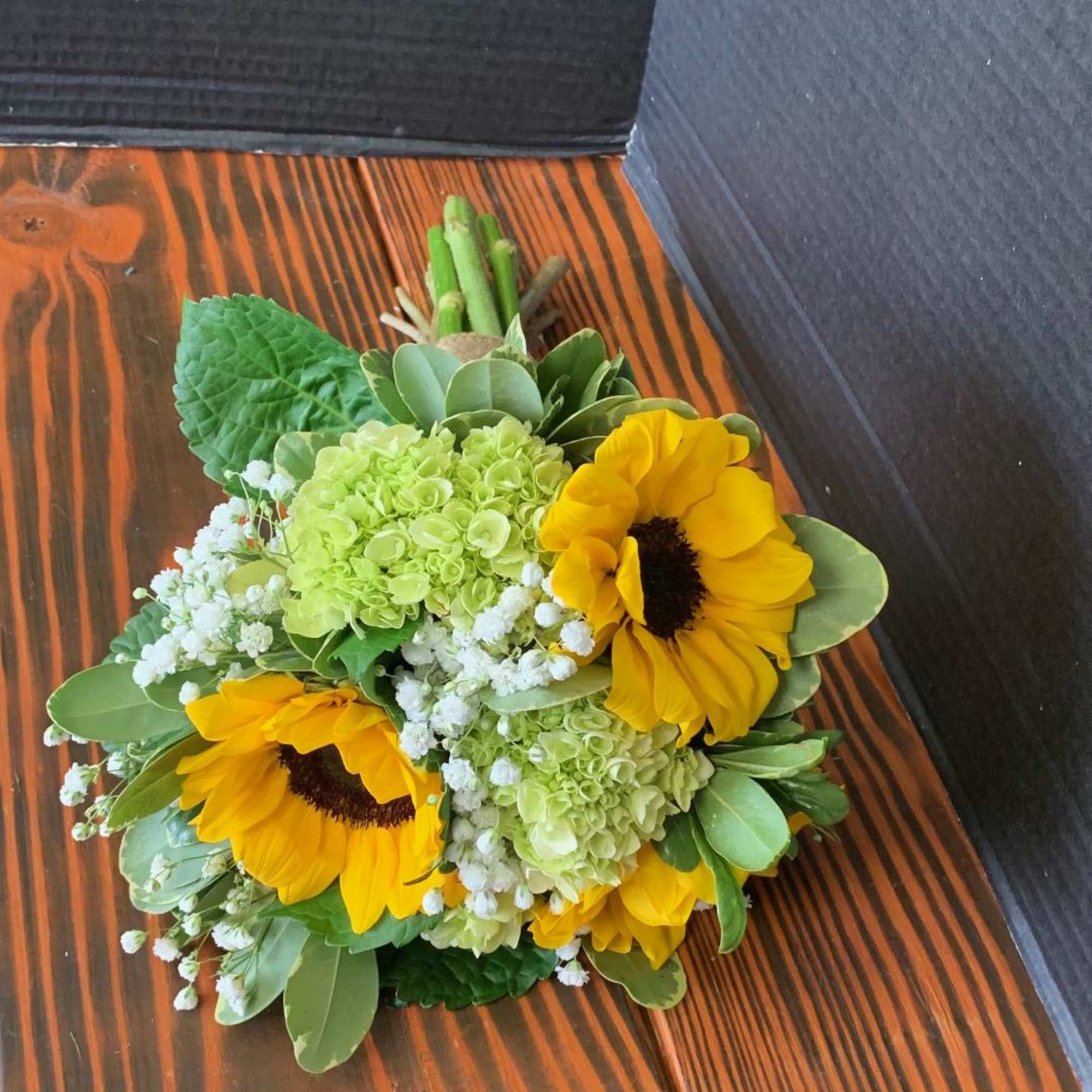 Bouquet of yellow sunflowers, green hydrangeas, and white baby's breath