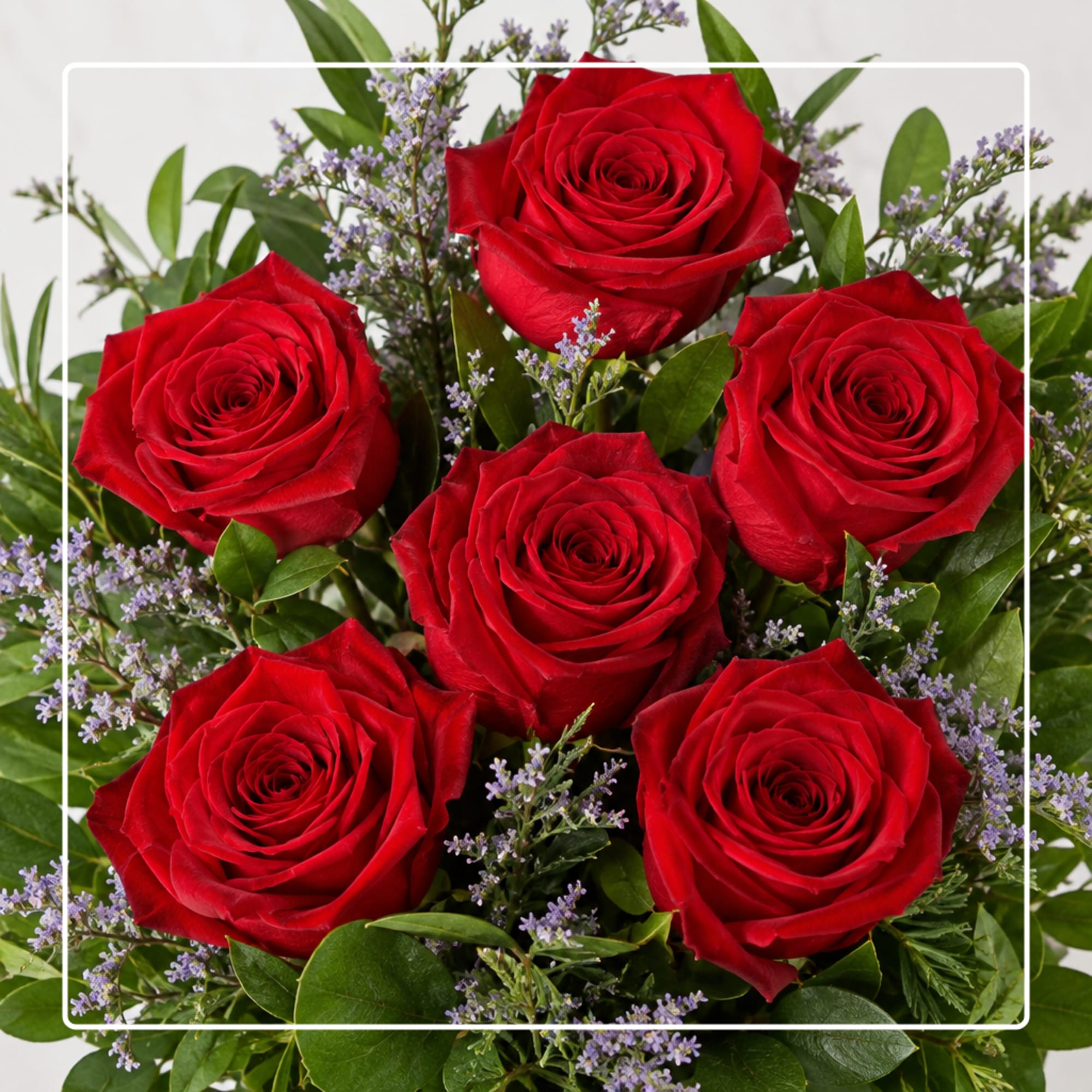 Bouquet of red roses with small purple filler flowers