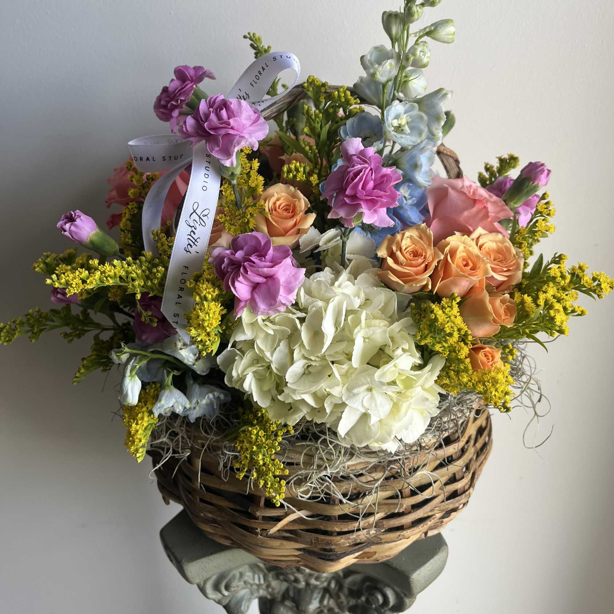 Elevate the classic basket arrangement with a custom-designed display of fresh, seasonal