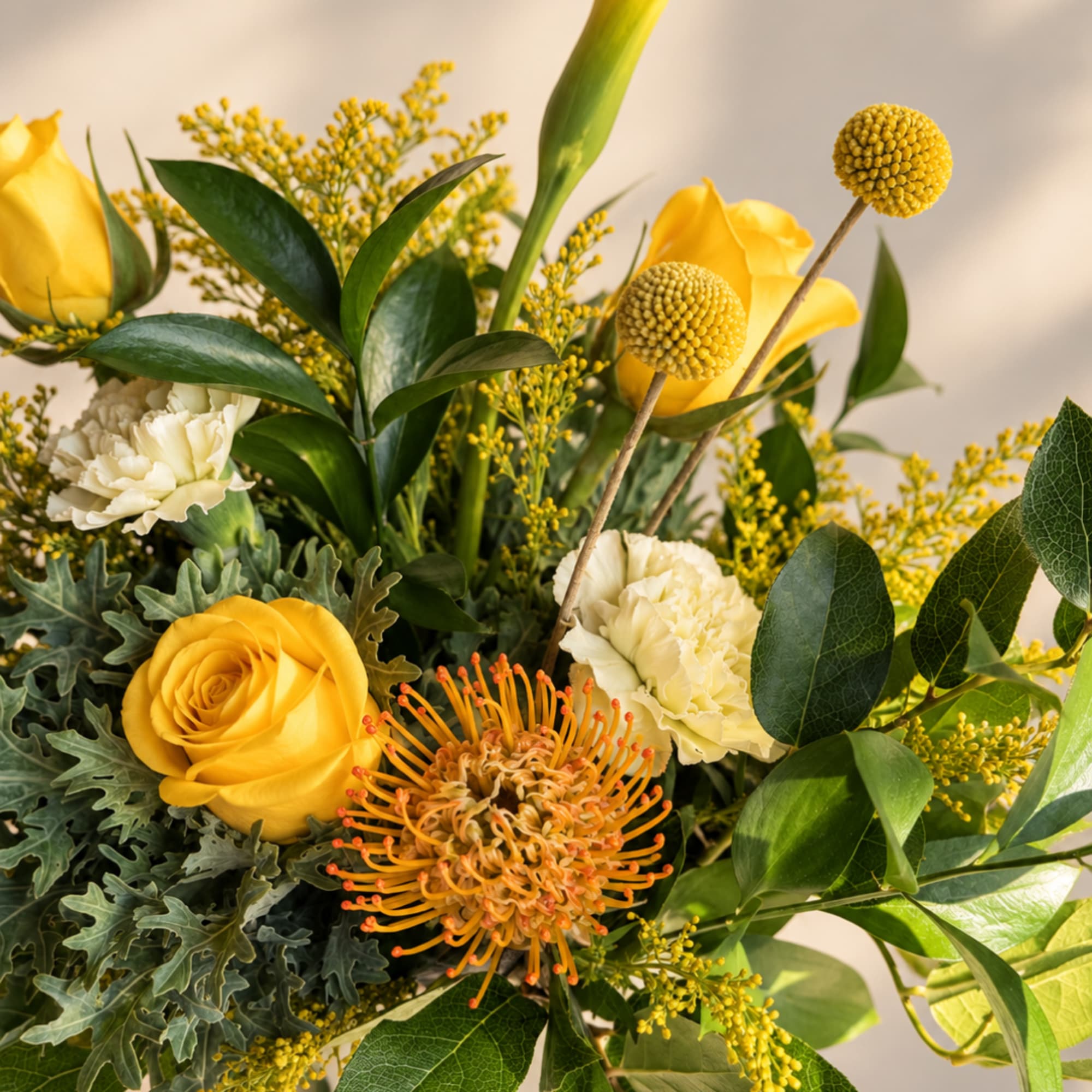 Yellow roses and cream carnations in a mixed bouquet