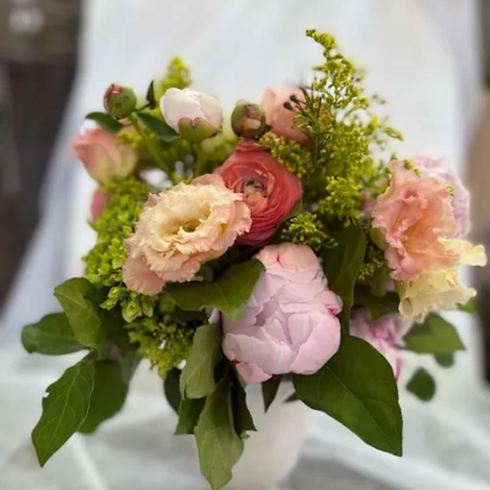 Bouquet of pink and peach flowers with green foliage