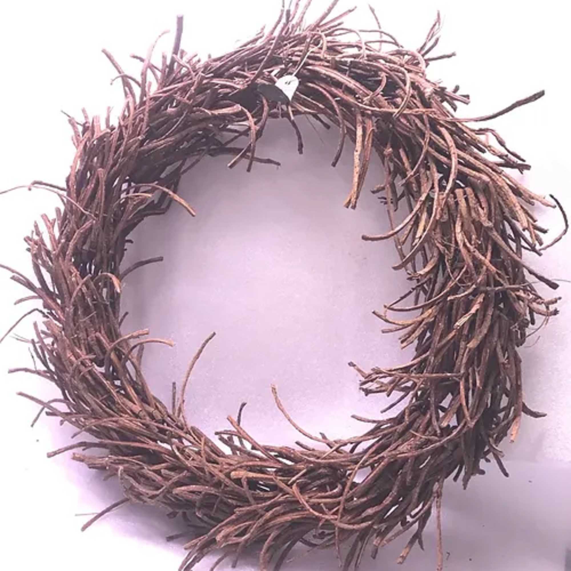A brown twig wreath on a white background