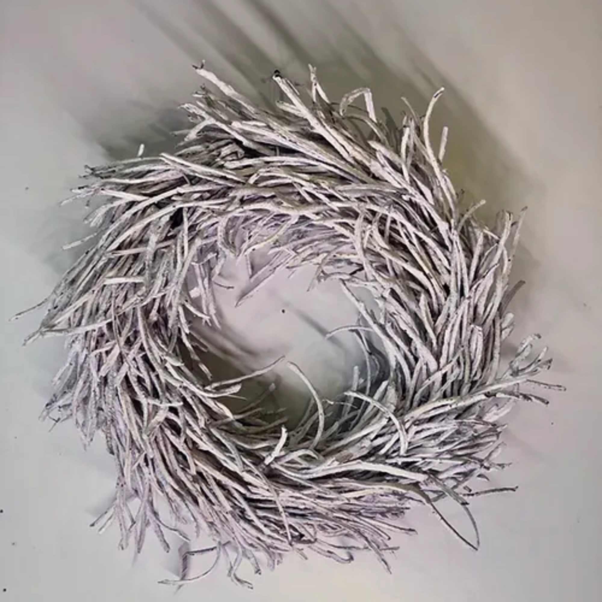 A white twig wreath with a circular opening