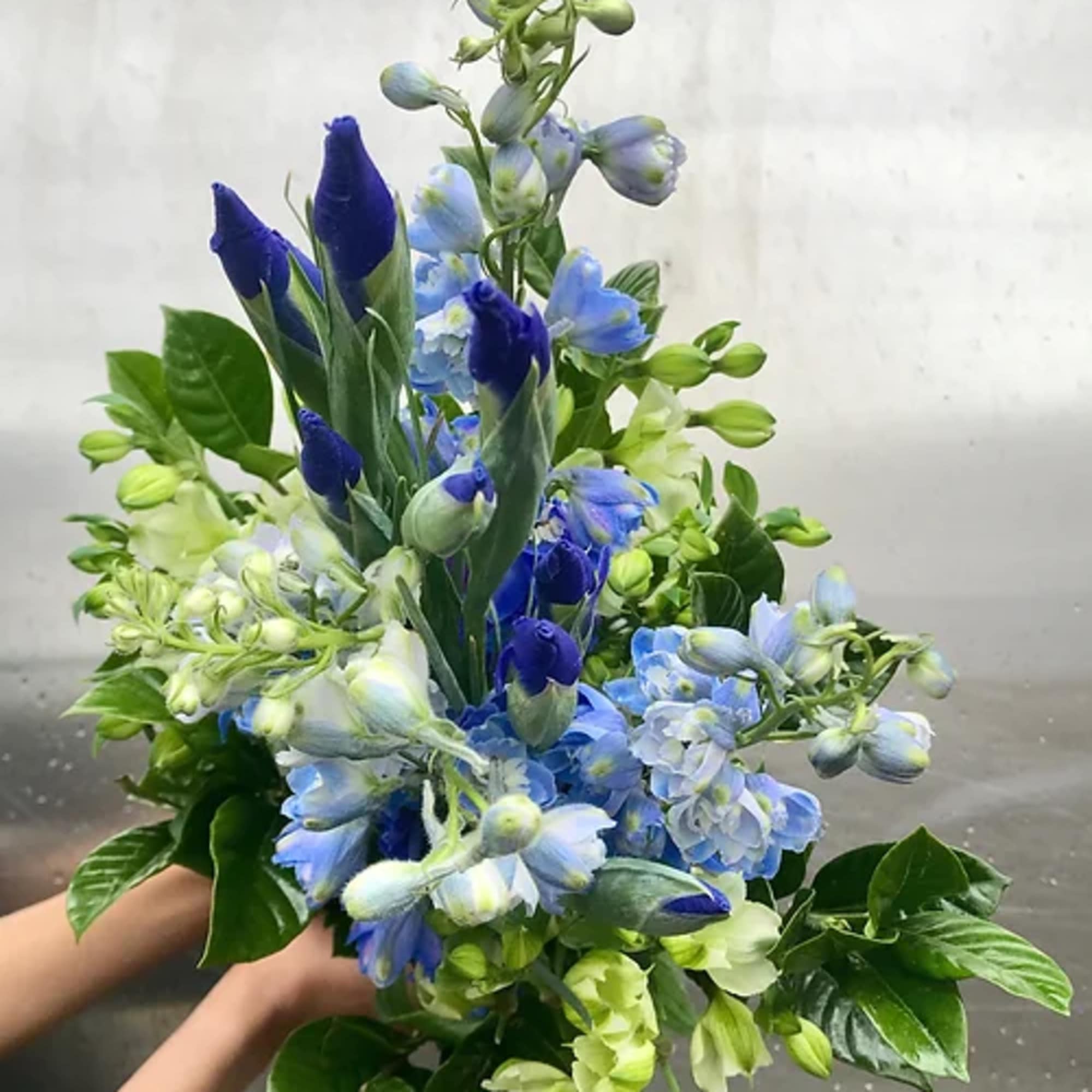 Blue and green mixed bouquet with tall buds and clustered blooms
