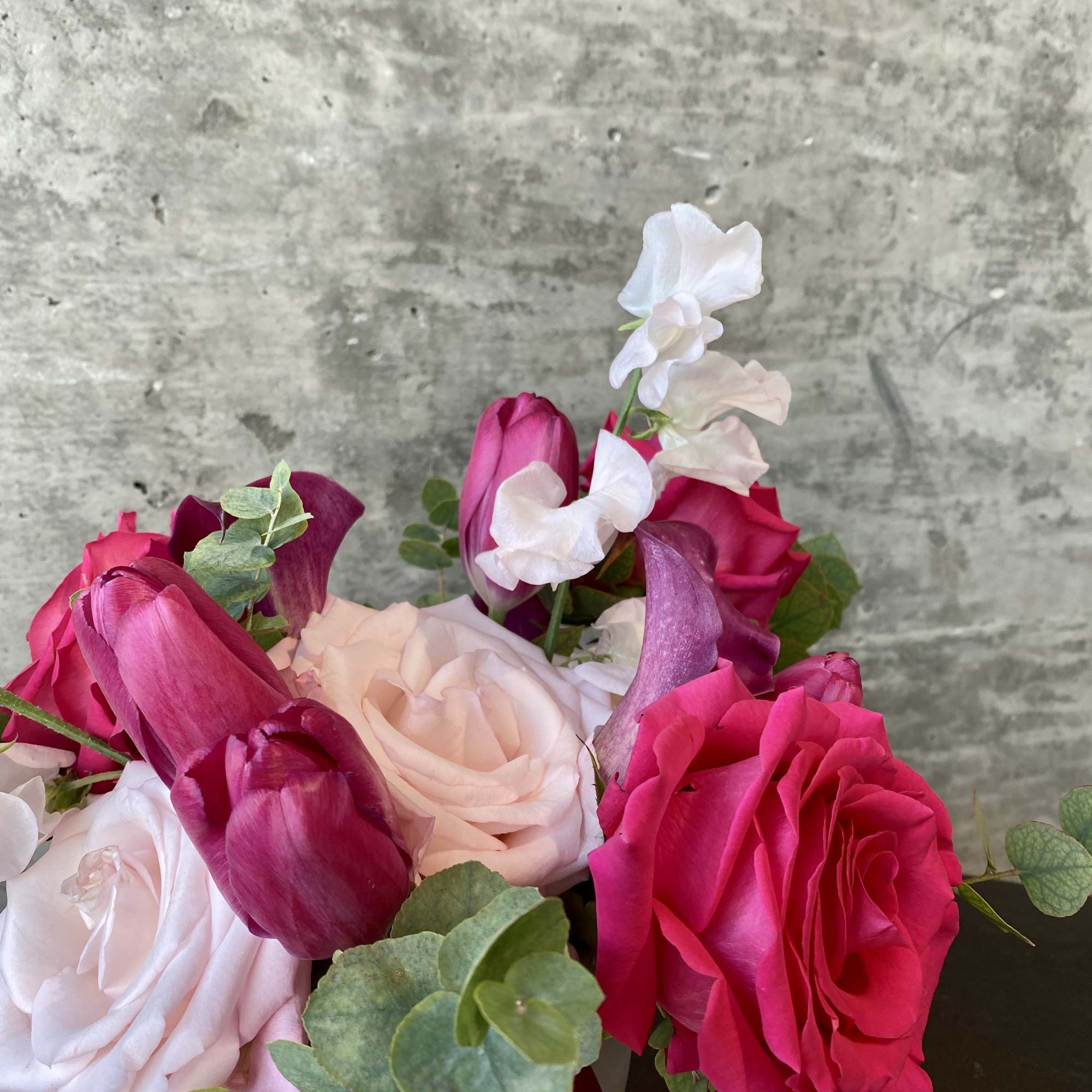 Bouquet of pink and white roses with tulips and eucalyptus