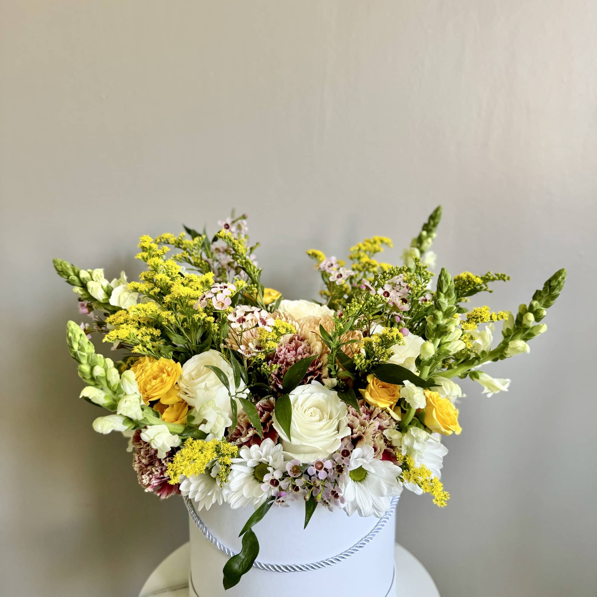 Mixed bouquet in a white hatbox with white, yellow, and pink flowers, photo 4 of 12