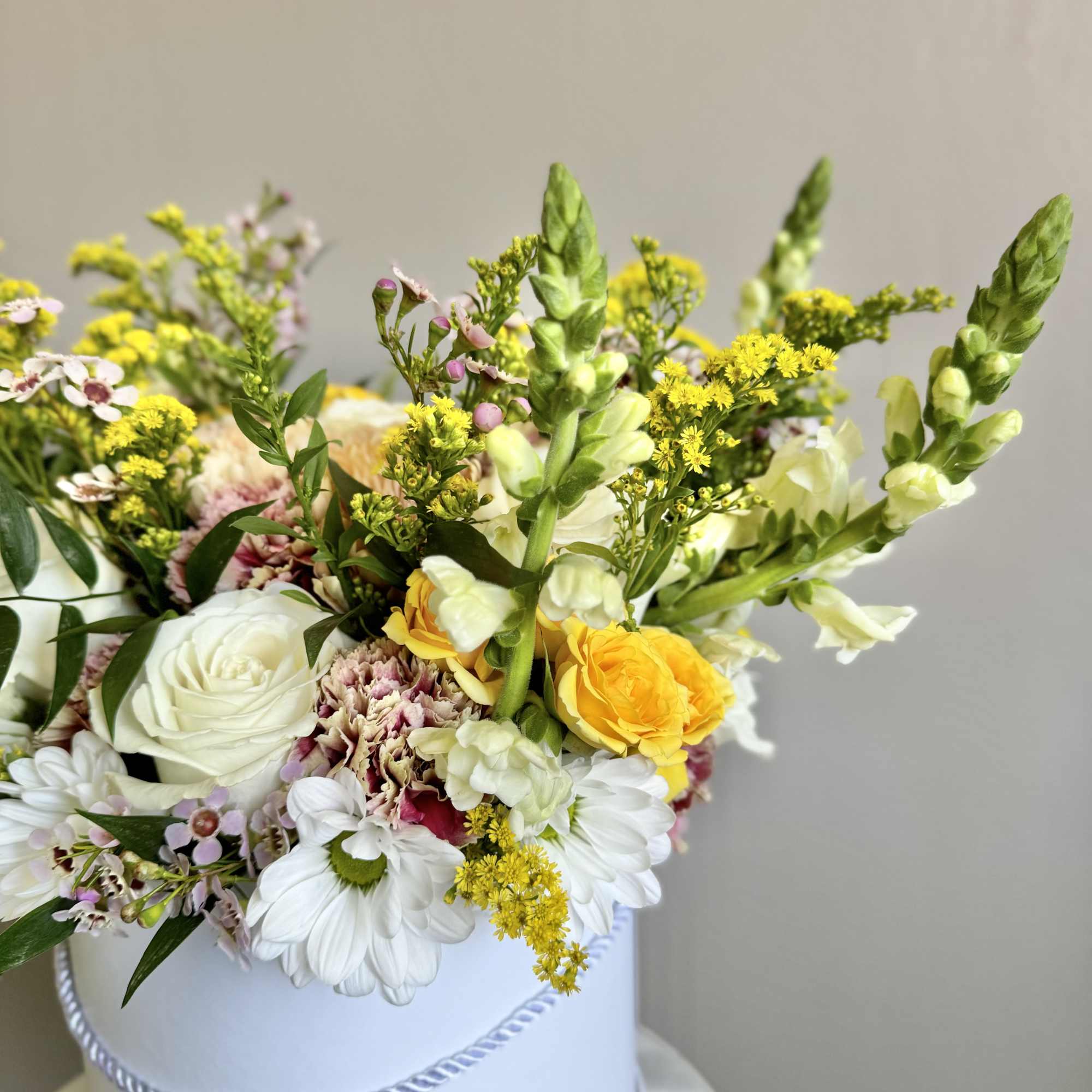 Mixed bouquet in a white hatbox with white, yellow, and pink flowers, photo 5 of 12